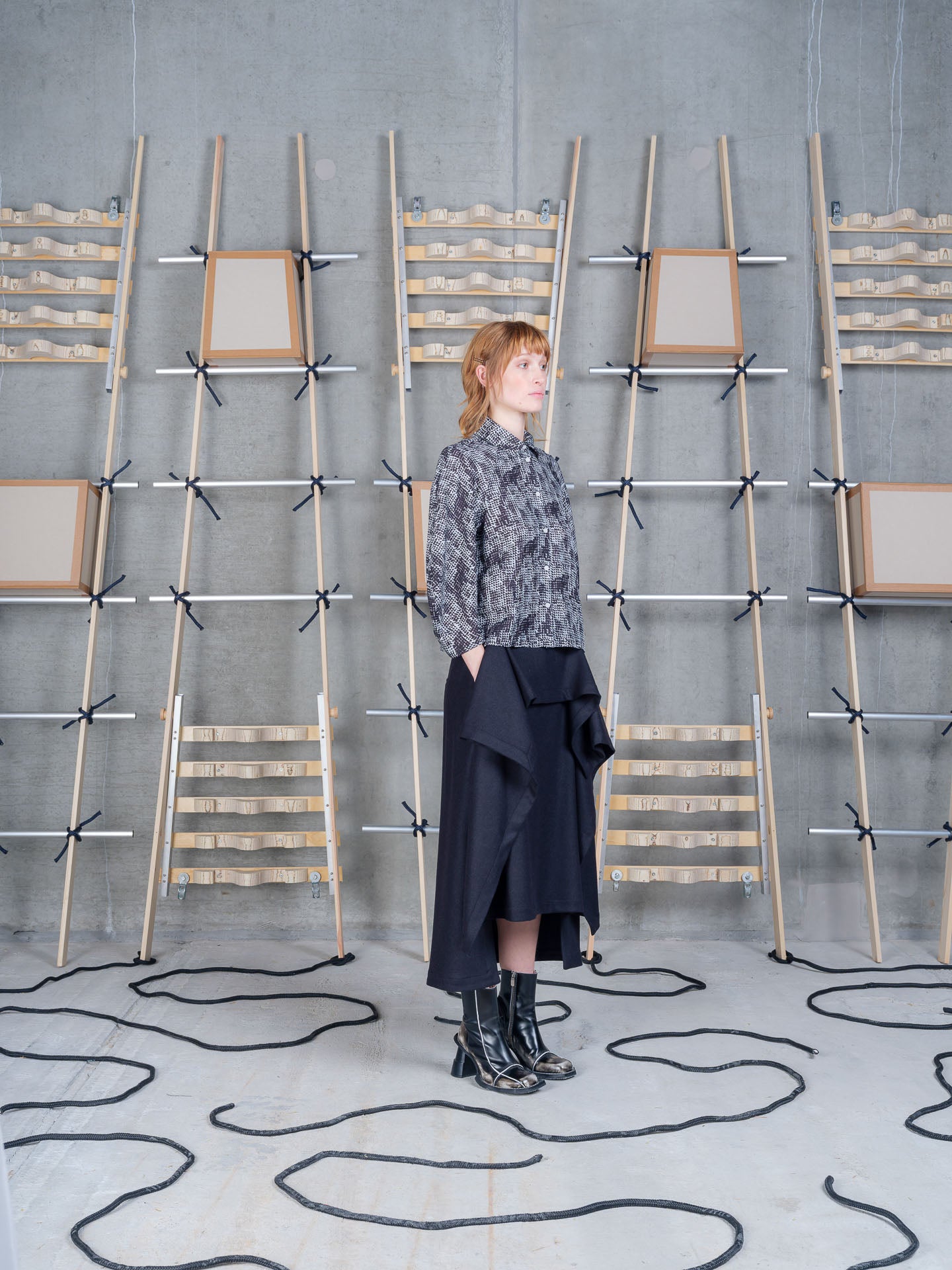 Model wearing Henrik Vibskov Blanket Skirt in Black three-quarter view