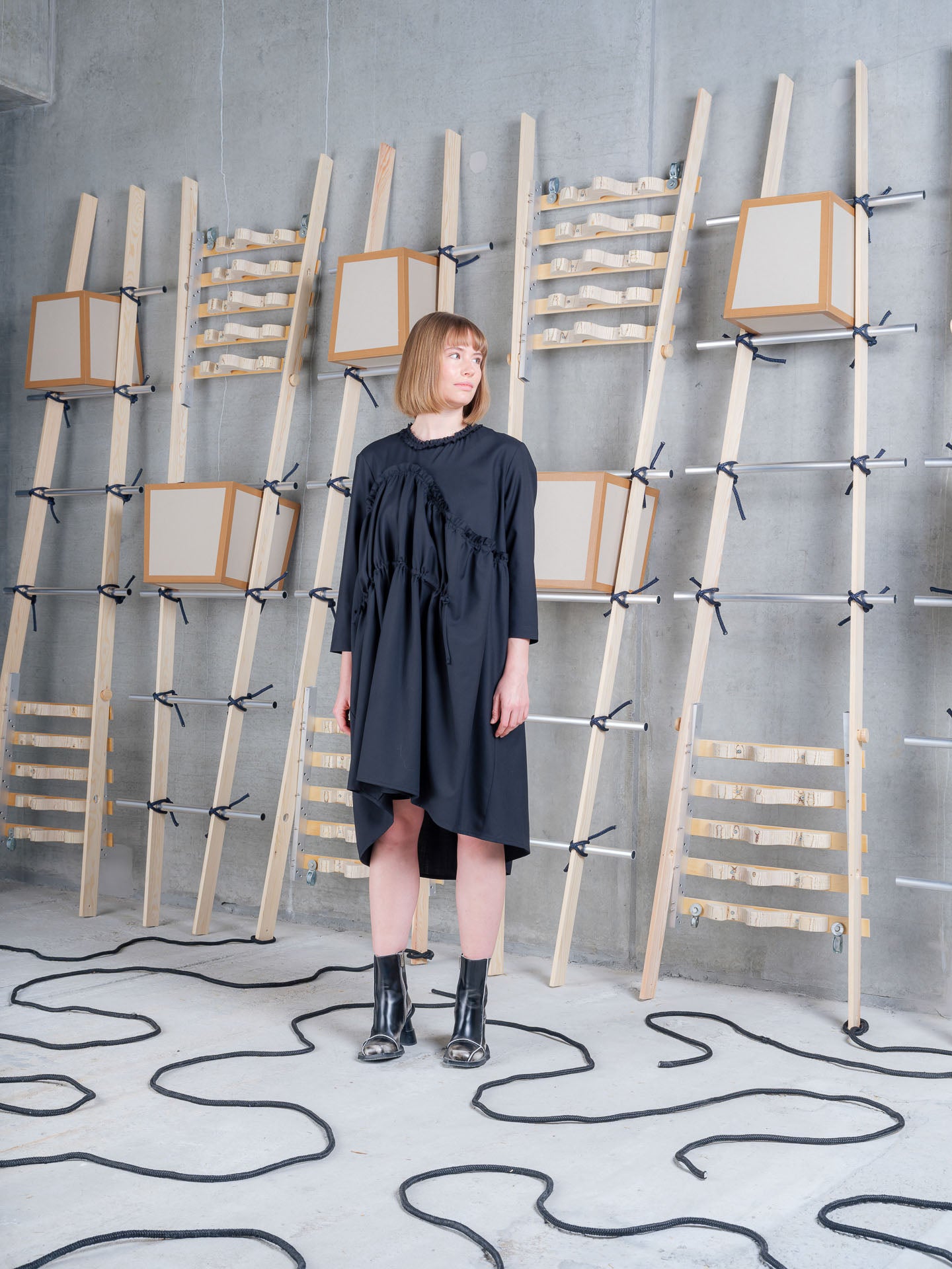 Model wearing Henrik Vibskov Bon Chalant Dress LS in Black front three-quarter view