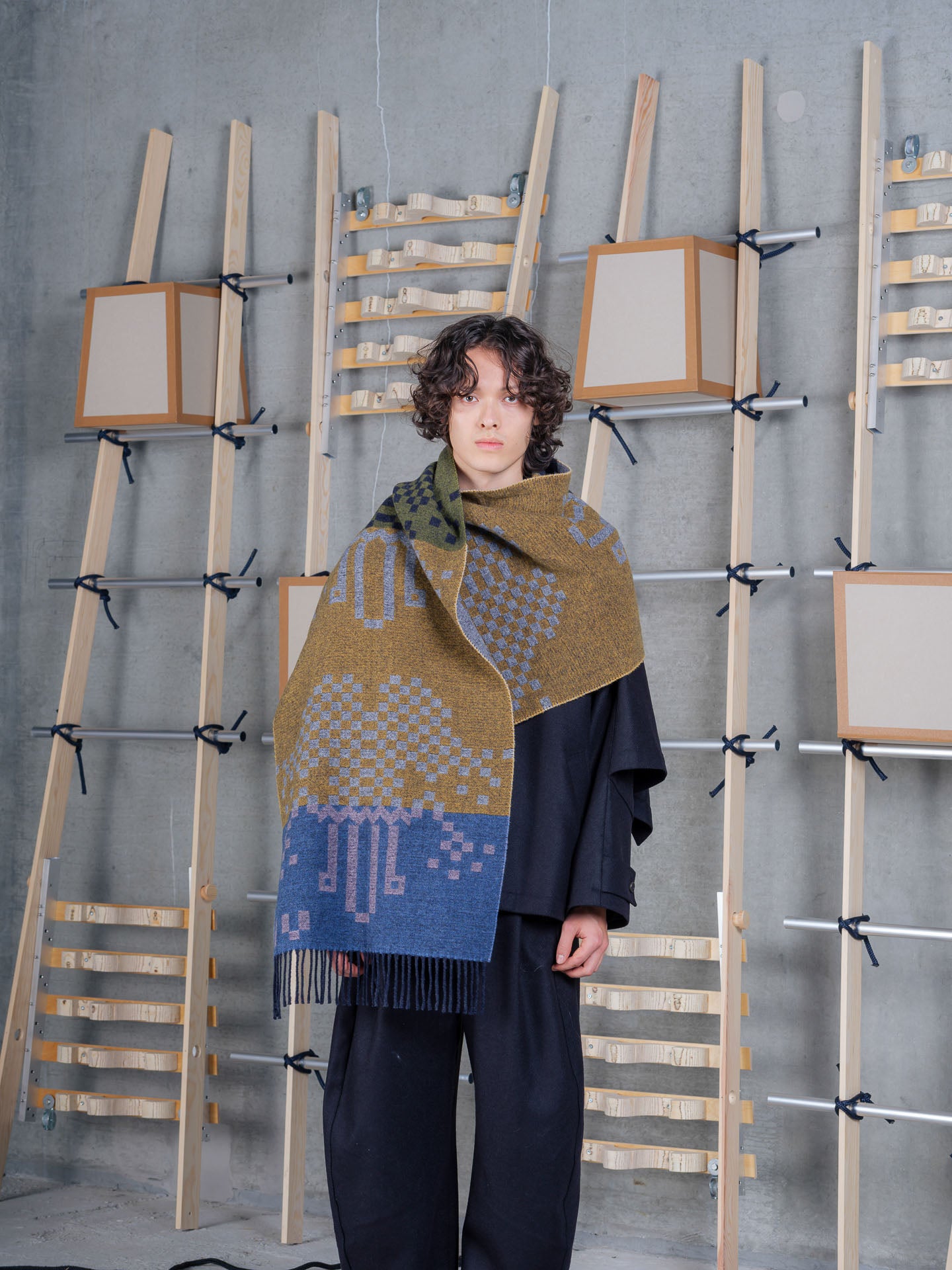 Model wrapped in Cross Stitch Scarf in Spice Purple Multi Cross by Henrik Vibskov