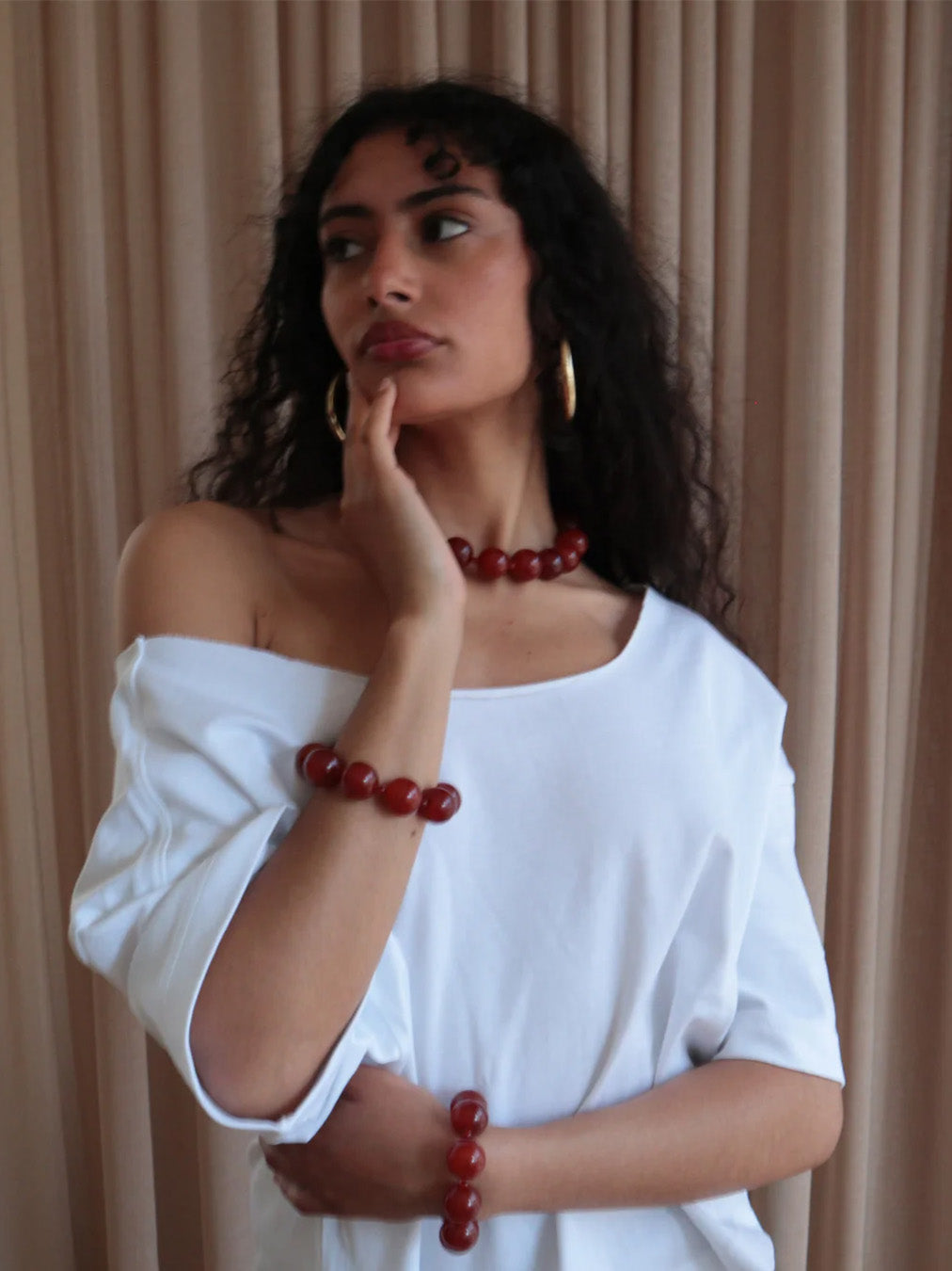 Woman wearing the red carnelian necklace with silver clasp from De Silang