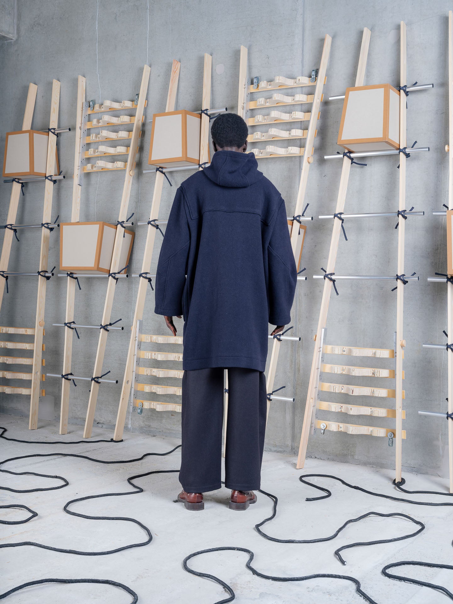 Model wearing Henrik Vibskov Duffle Coat in Navy Duffle back view