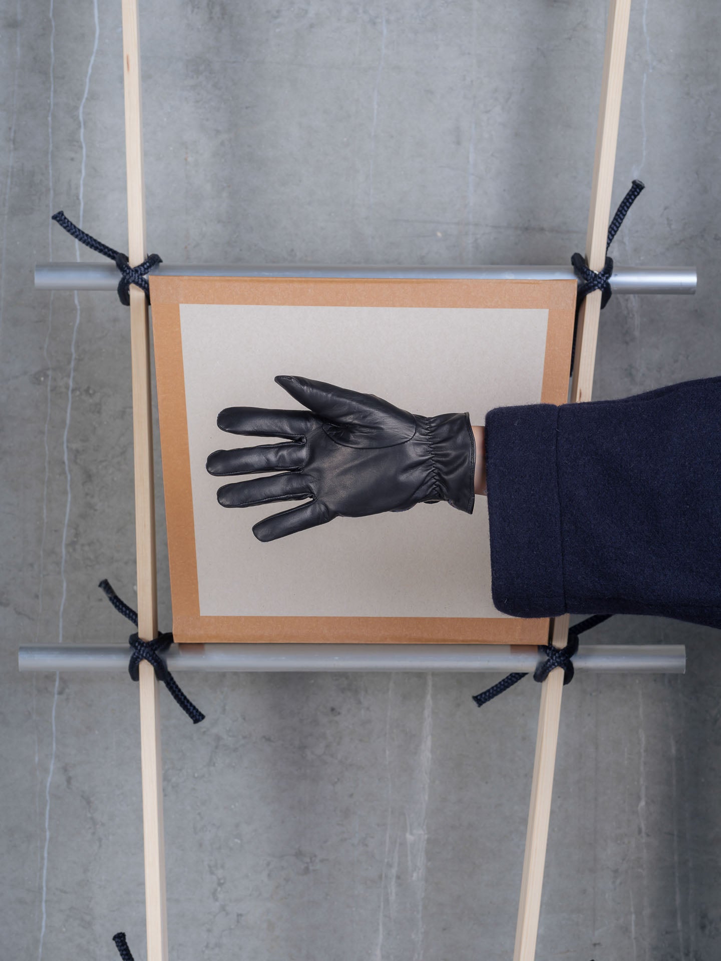 Henrik Vibskov HV Gloves in Blue Wool Checks worn on the hand, showcasing the leather palm and check pattern.