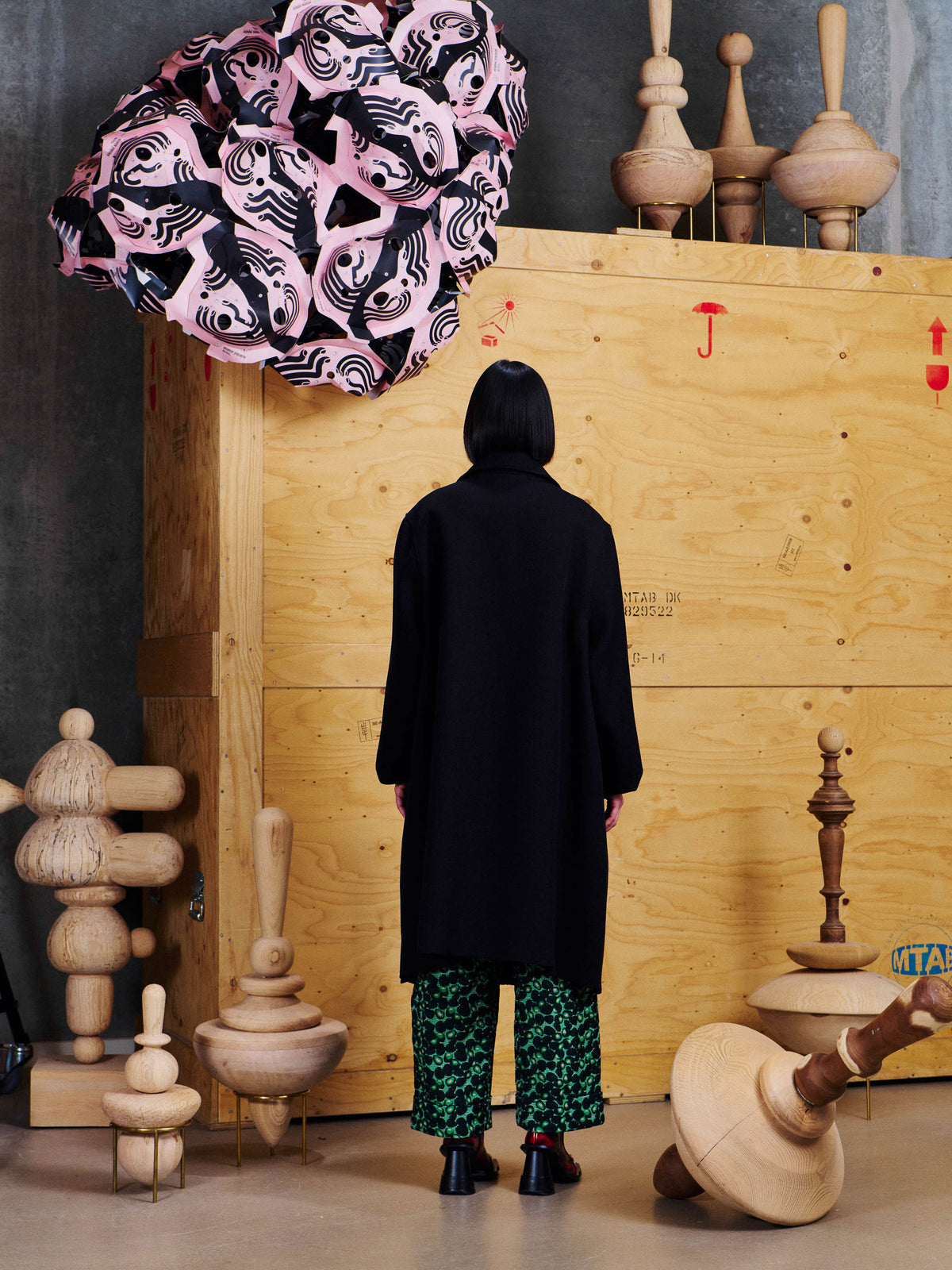 Henrik Vibskov 3D Coat in Black styled on model from the back, showing clean longline silhouette, straight sleeves and softly structured shape. ID: ARCHIVE-F602
