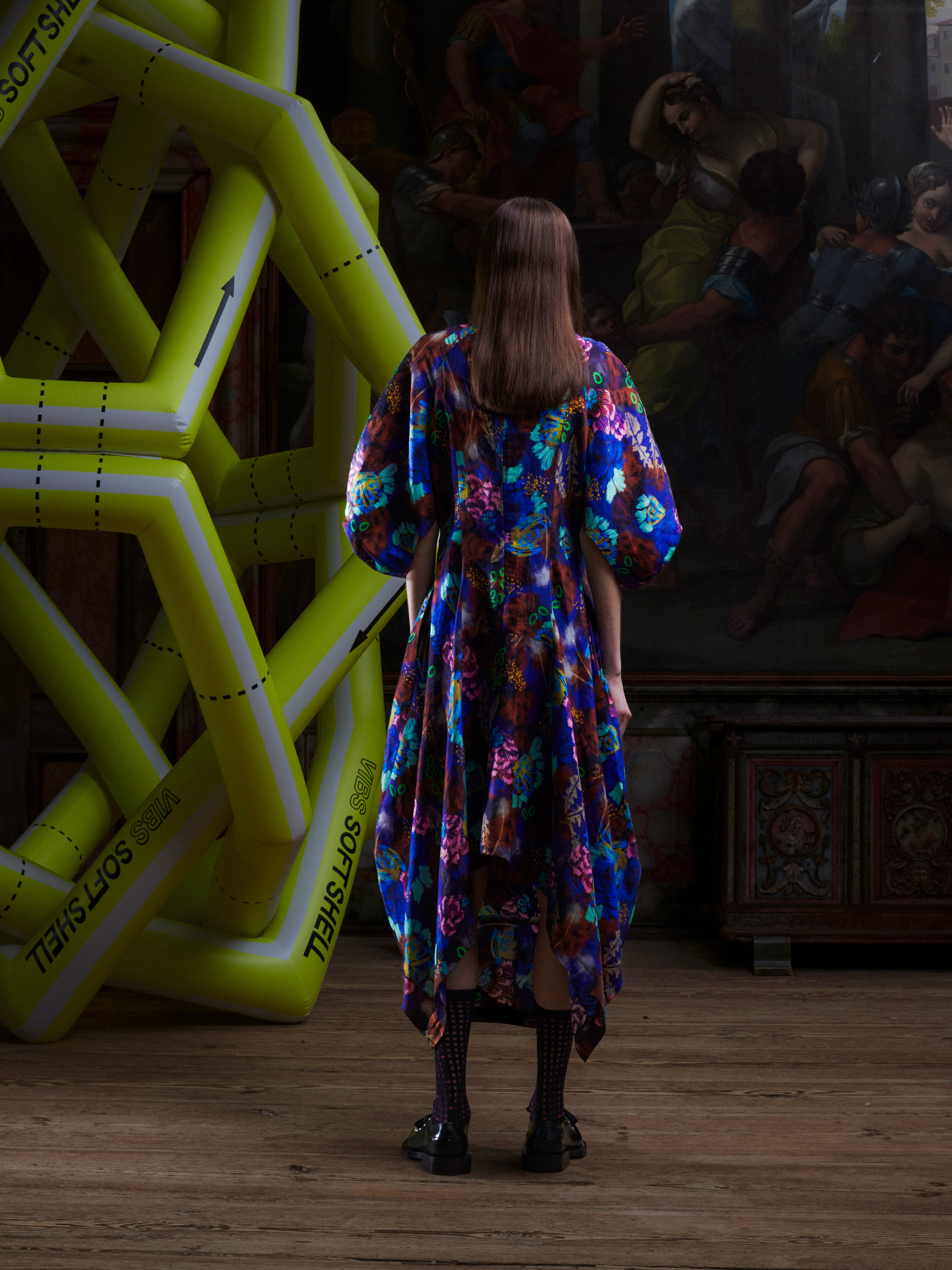 Back view of model wearing the Double Bass Dress in Space Chickens, highlighting the full multicolour abstract print and structured silhouette.