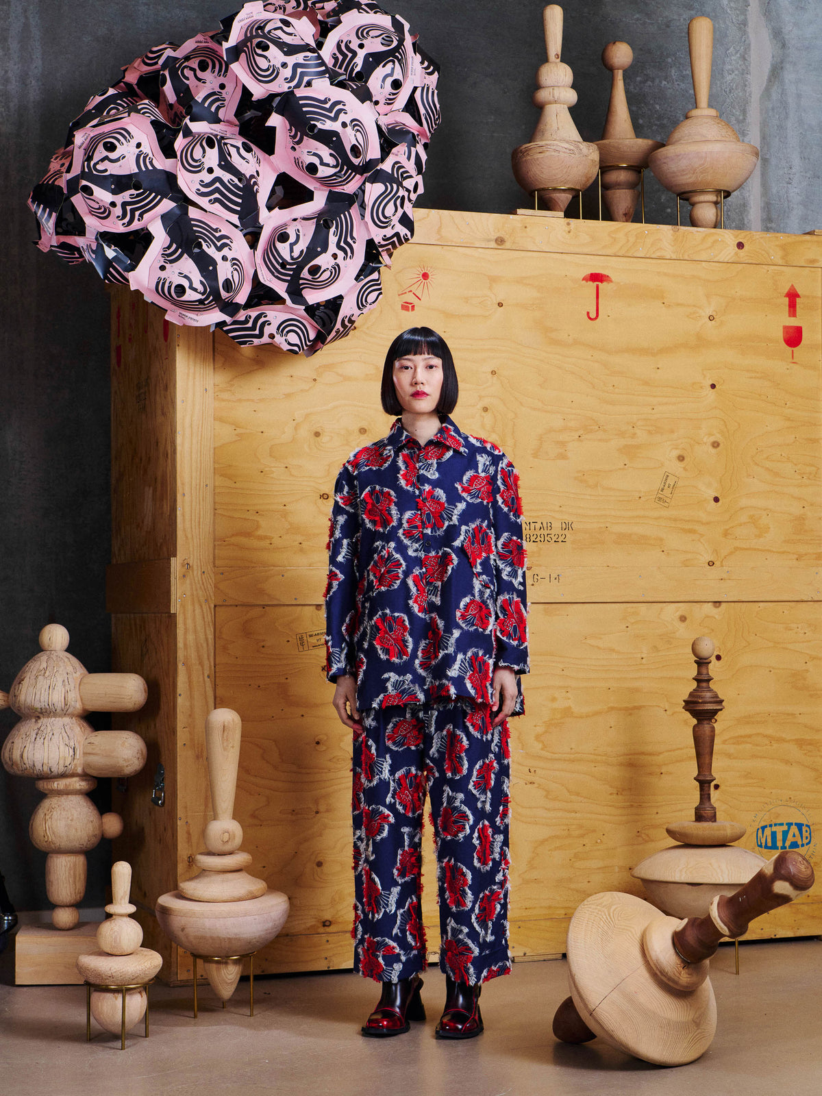 Model wearing the Henrik Vibskov Love You Blouse in Red Navy Birdy from the front with matching trousers, showing the relaxed longline silhouette.