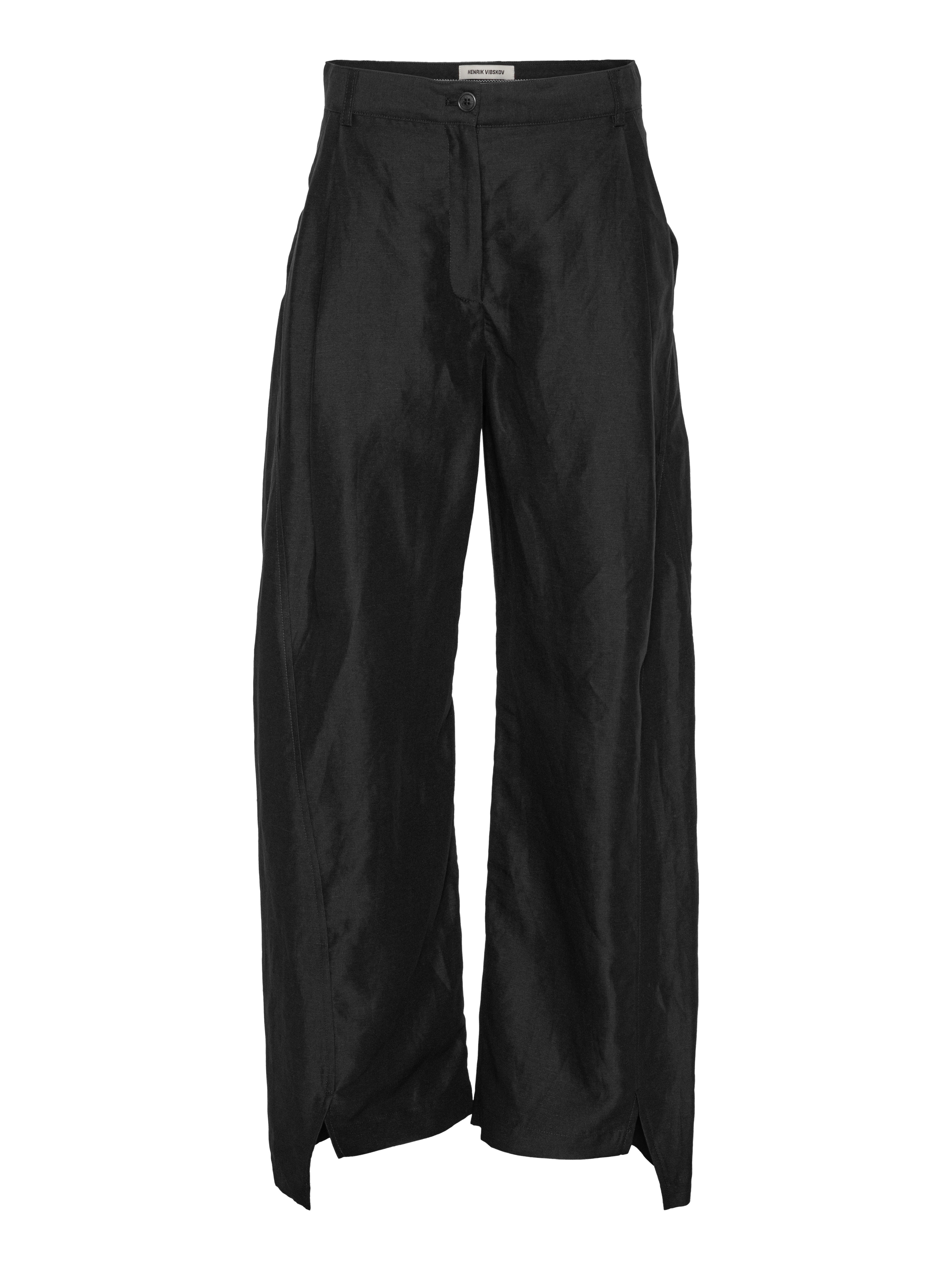 Front view of Henrik Vibskov Merge Pants in black Tencel-linen blend with wide legs and subtle high-low hem detail.