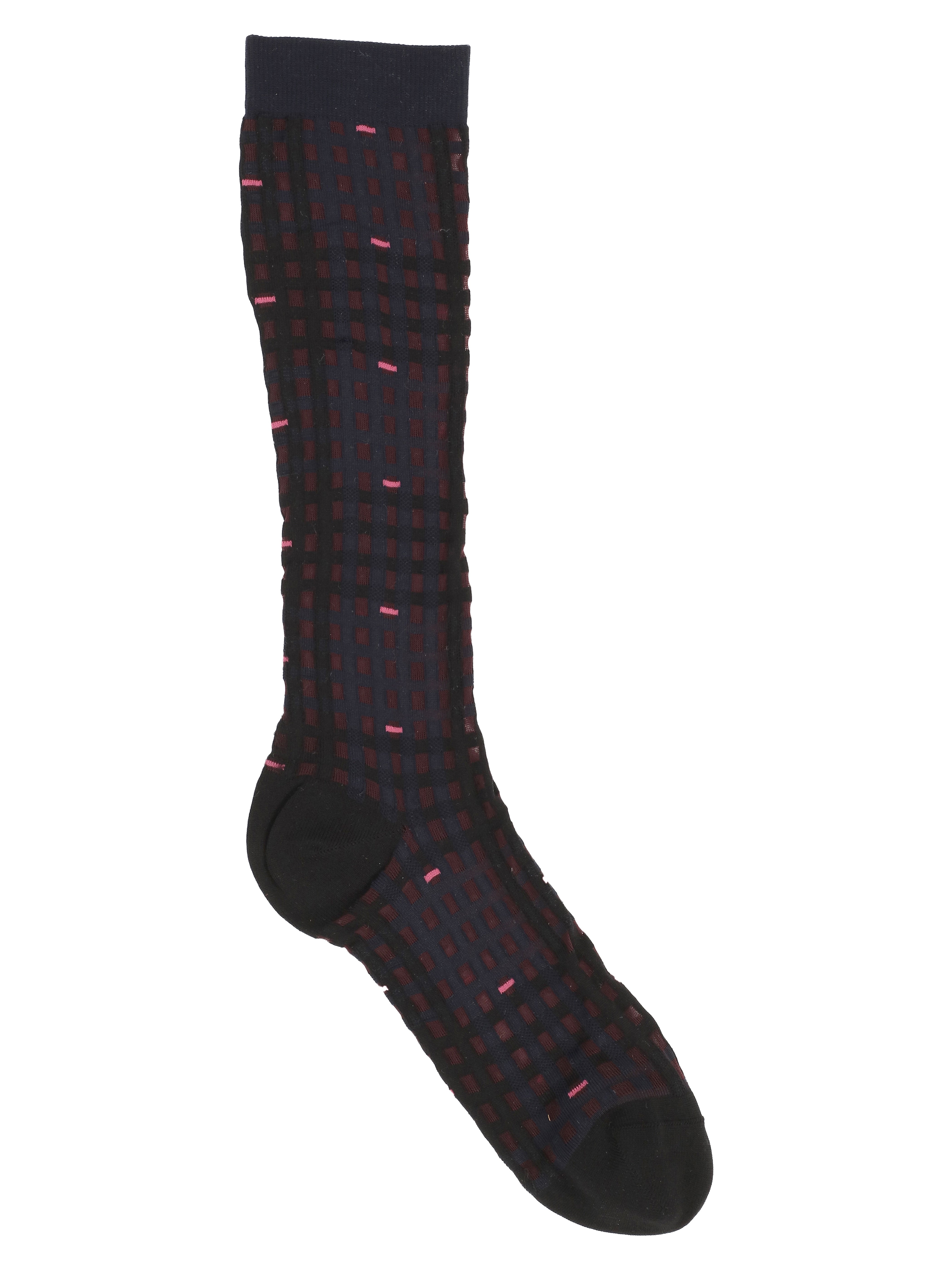 Knee-length socks with a navy checkered pattern from Henrik Vibskov on a white background.