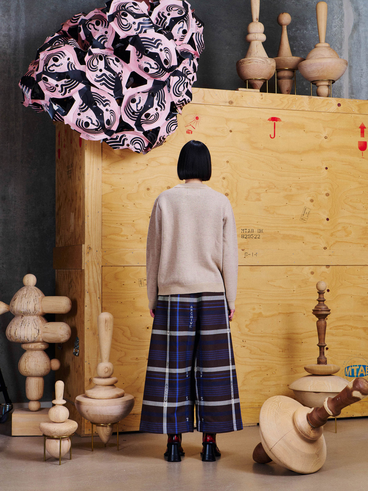 Back view of model wearing the Henrik Vibskov Salami Knit Sweat in Table Servings, showing the plain knitted back and straight silhouette.