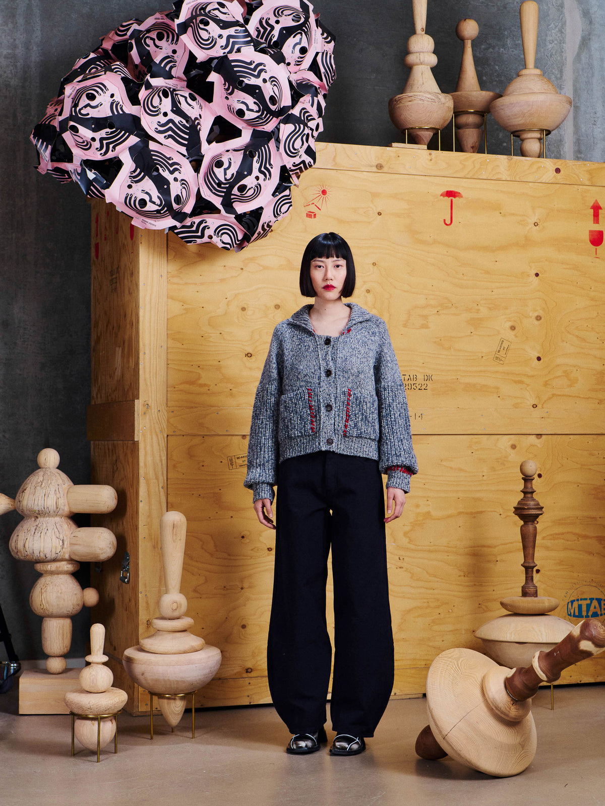 Model wearing the Henrik Vibskov Stitch Cardigan in Red Stitch Grey Melange from the front, showing the relaxed boxy fit and patch pockets.
