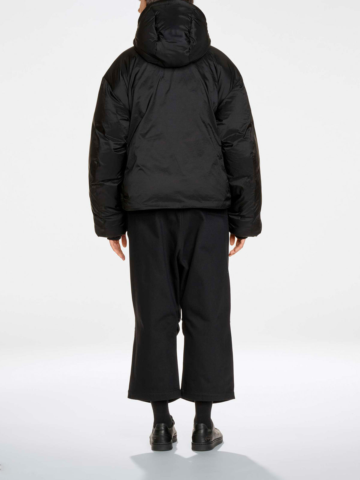 Y-3 Hooded Puffer Jacket in Black - full length back view on model showing oversized silhouette and belted waist