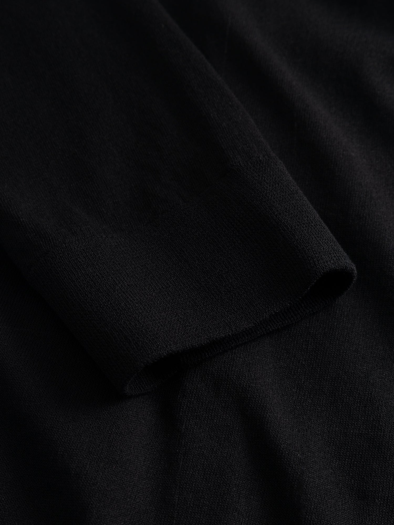 Kiko Kostadinov Woman Kreiner Knit Cardigan, close-up of the draped black knit fabric showing the fine, lightweight texture and subtle contrast between the sheer body and ribbed trim