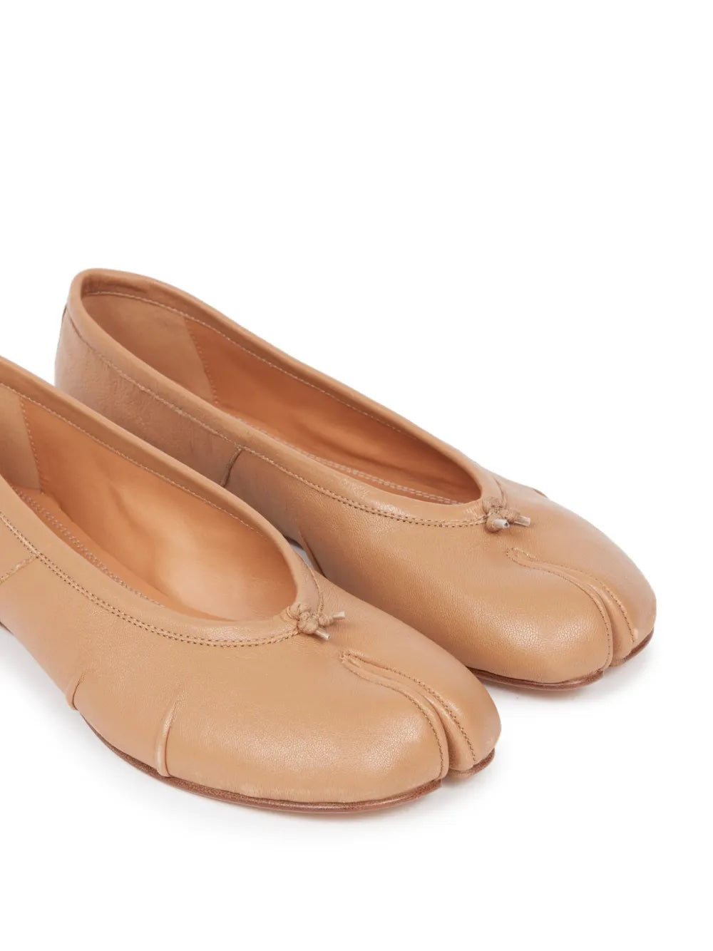 Pair of tan leather shoes on a white background