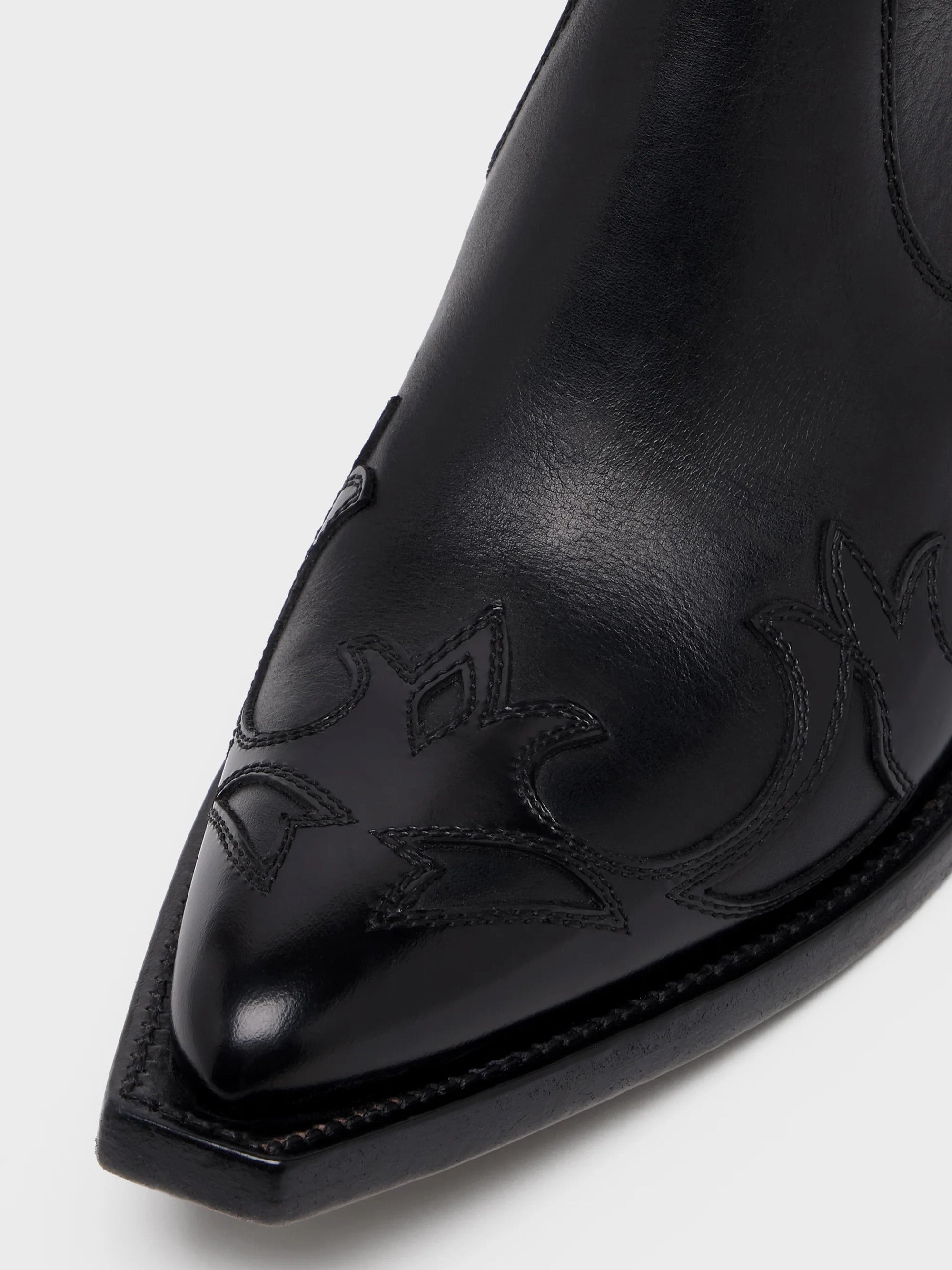 Close-up of Maison Margiela Heel-Less Western Flame Boot showing tonal flame appliqué detail at pointed toe