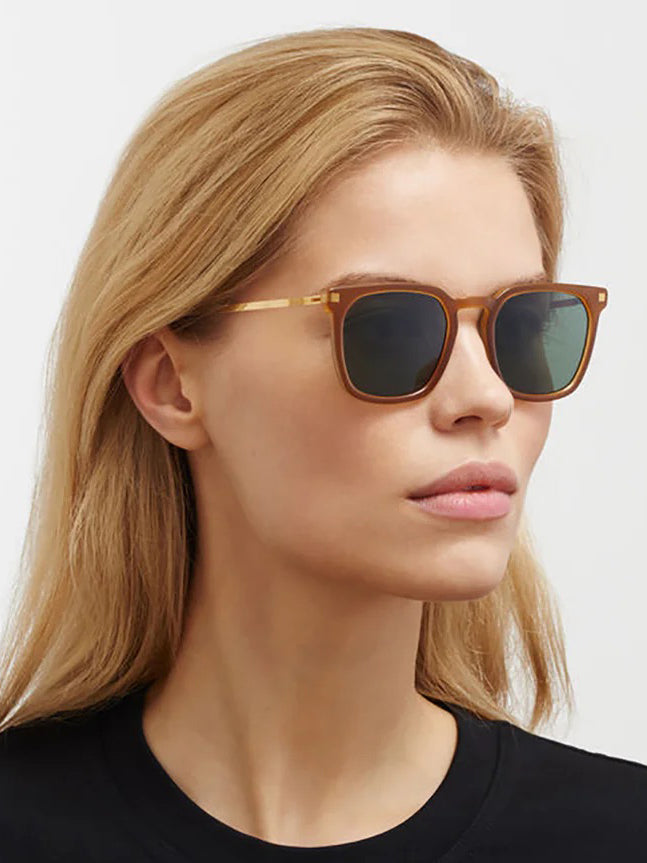 Mykita Borga Sunglasses in Brown Glossy Gold on-model side profile view, ultra-light stainless steel temples, gold-tone hardware, amber acetate frame