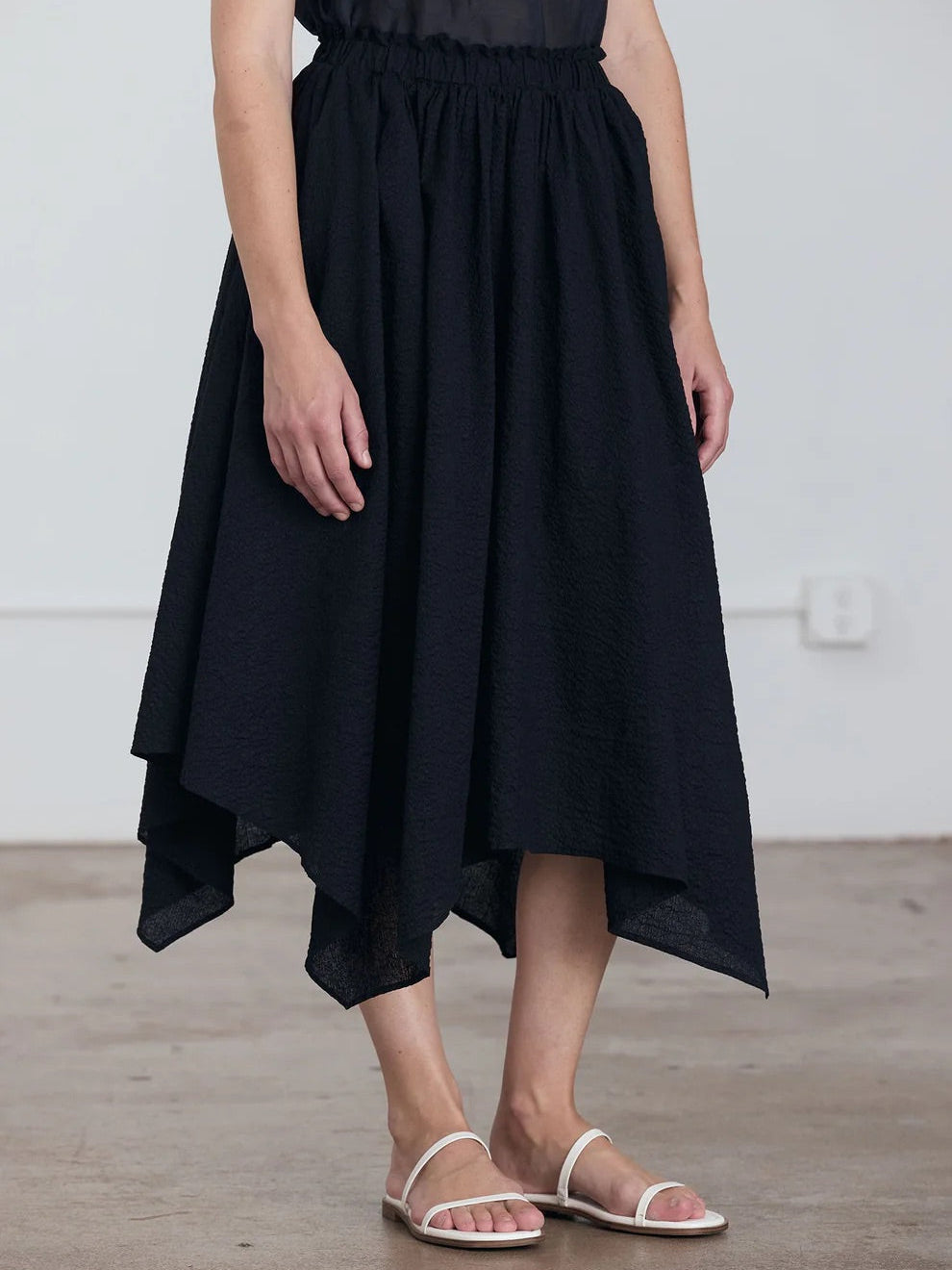 Black Crane Paper Skirt in Midnight - front view on model showing A-line silhouette and elasticised waistband