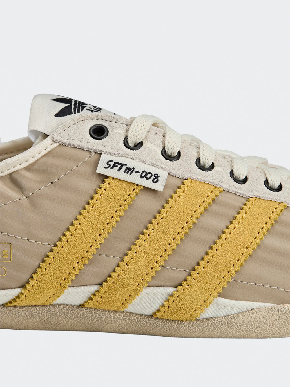 Adidas Tokyo W SFTM in Off White/Yellow/Black - three-quarter side view showing yellow three stripes and off white silhouette