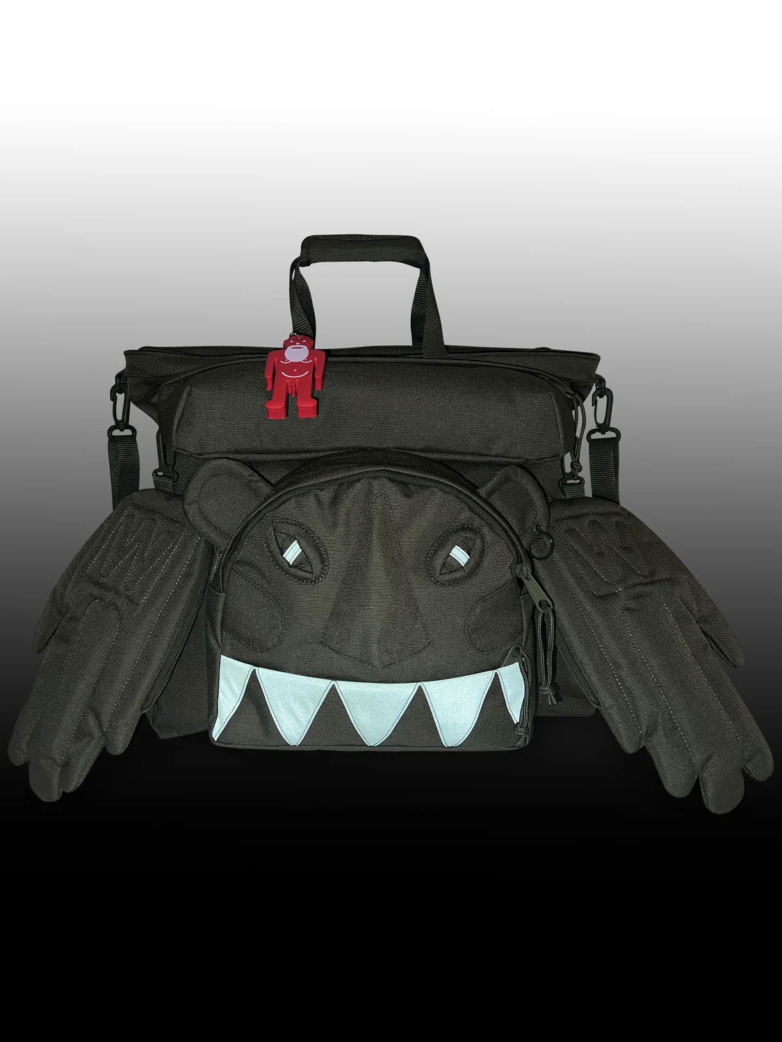 Walter Van Beirendonck x Eastpak Walter Carry Bag in low light showing reflective Monster eyes and teeth detailing