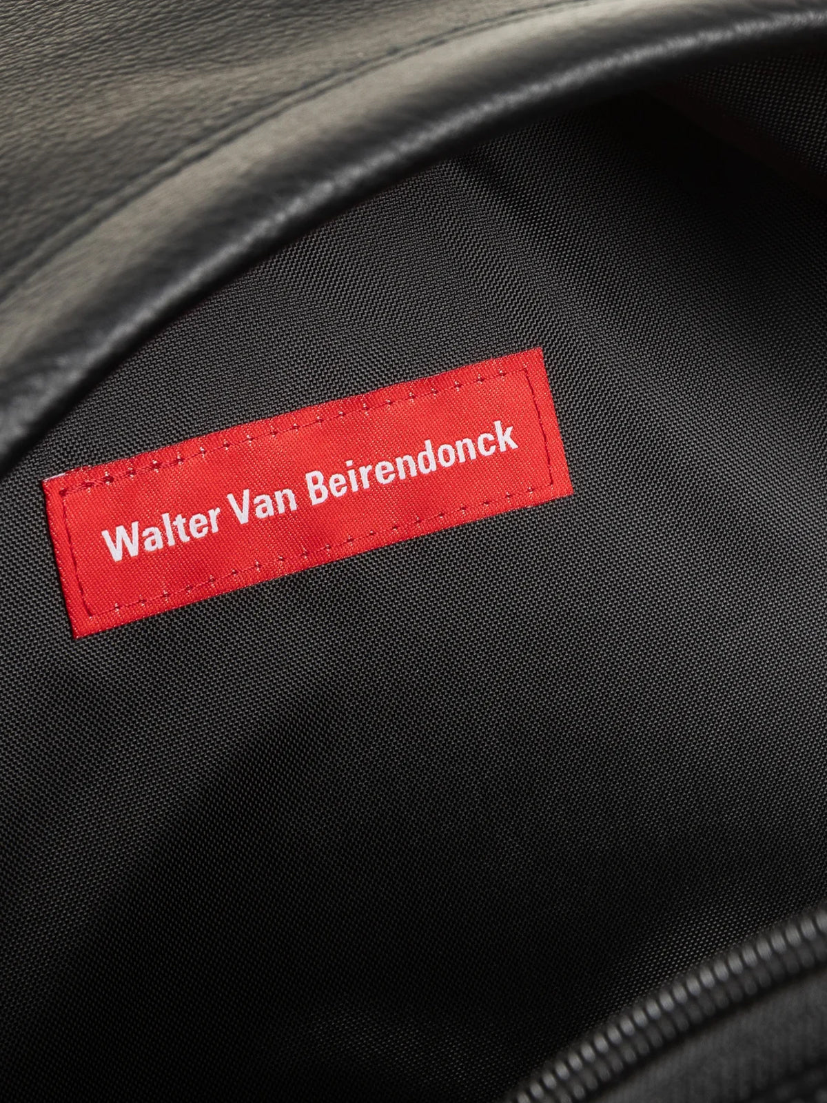 Walter Van Beirendonck Walter Pak'r in Black Faux Leather, close-up of the interior with red Walter Van Beirendonck label.
