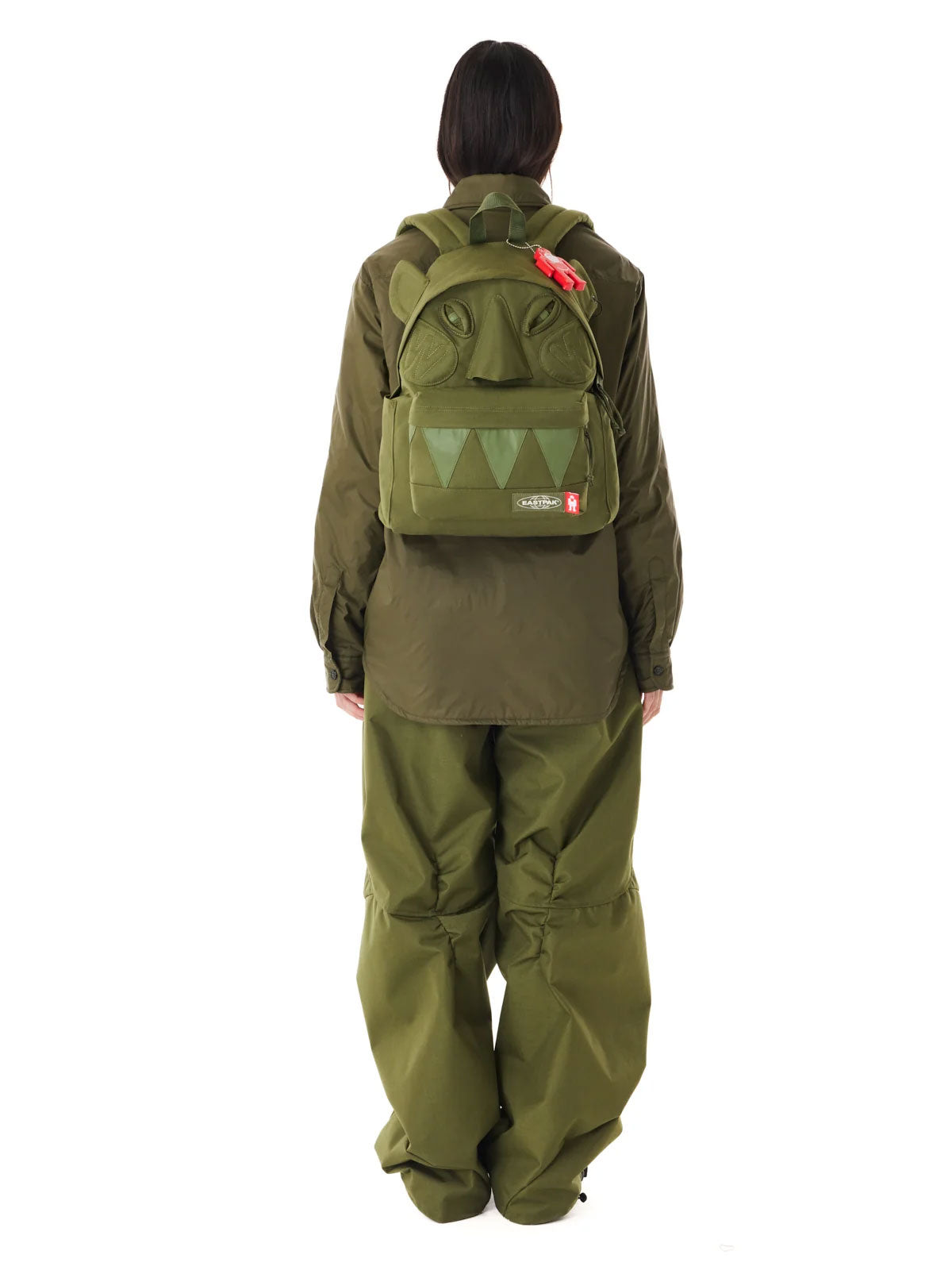 Walter Van Beirendonck x Eastpak Walter Pak'r backpack in khaki worn on the back, showing the sculptural Monster face design.