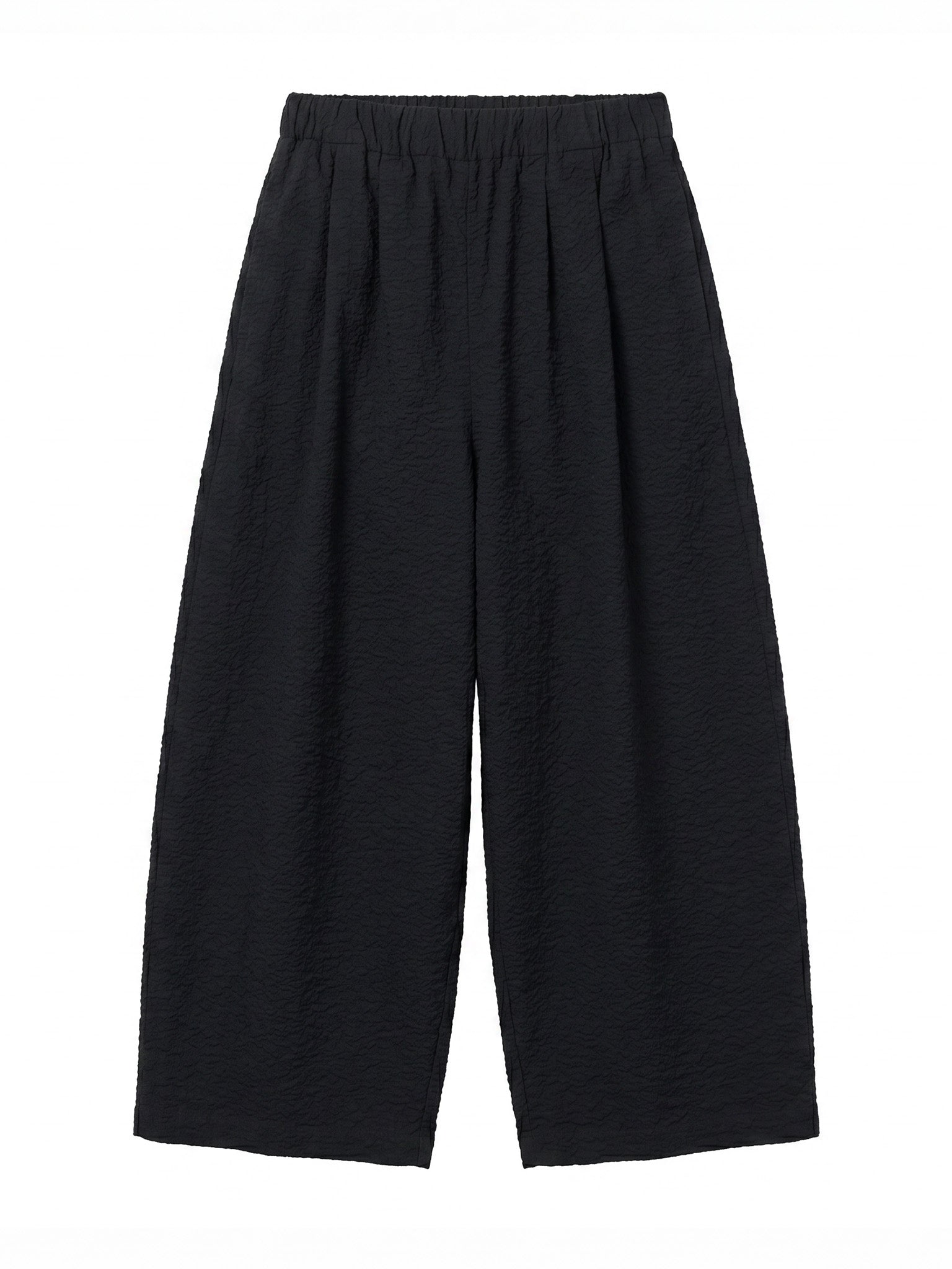 Black Crane Wide Pants in Midnight - flat lay showing wide silhouette and elasticised waistband in ripple textured Japanese cotton