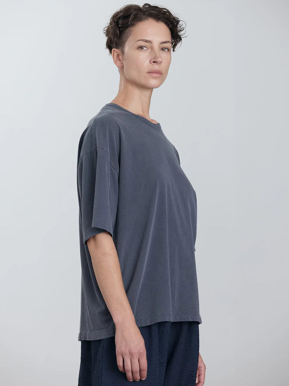 Black Crane Wide Short Sleeve Tee in Indigo - three-quarter view on model showing dropped shoulder and relaxed fit