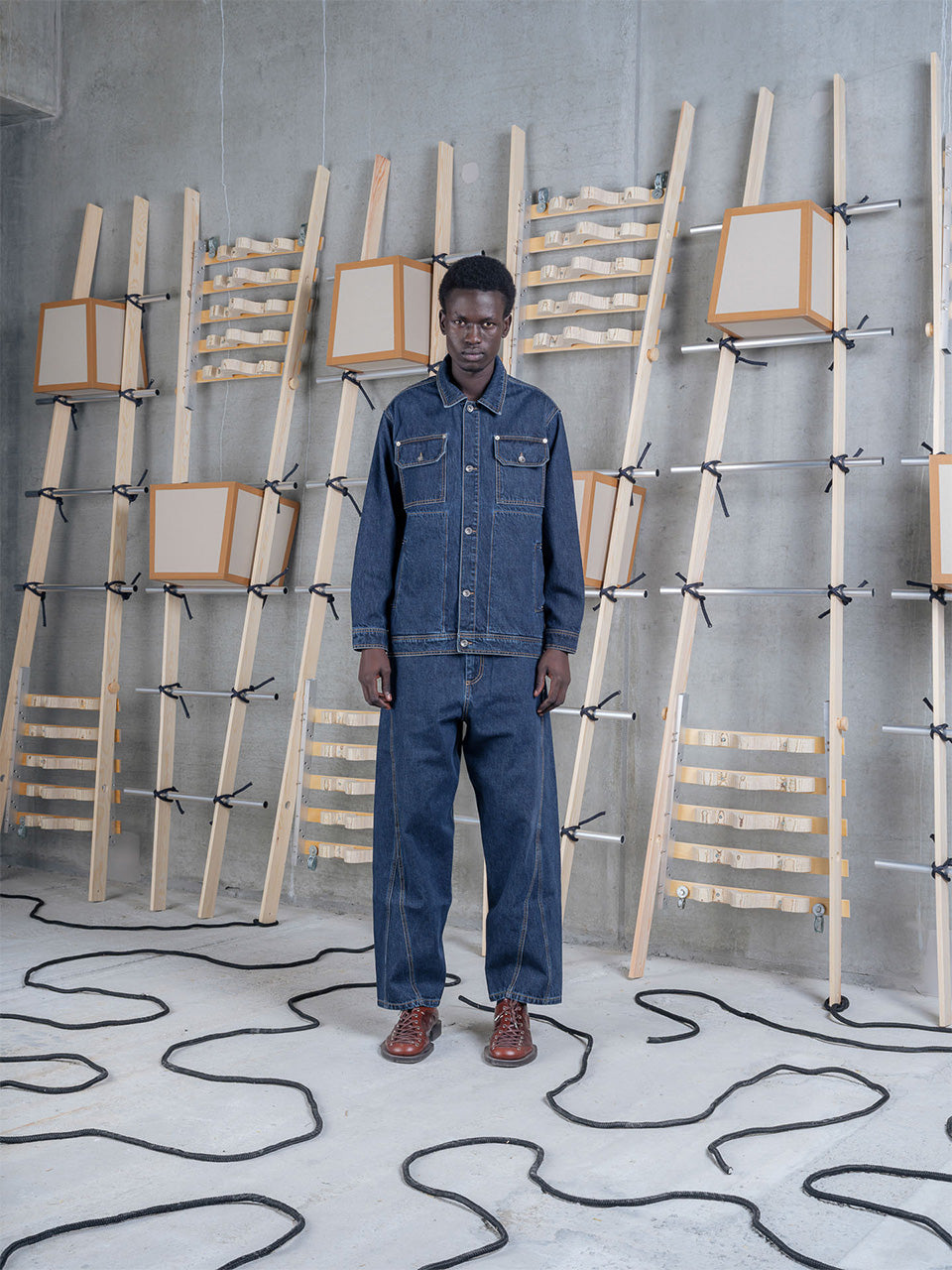 Model wearing Amphi Pants in Rinse Denim by Henrik Vibskov front view