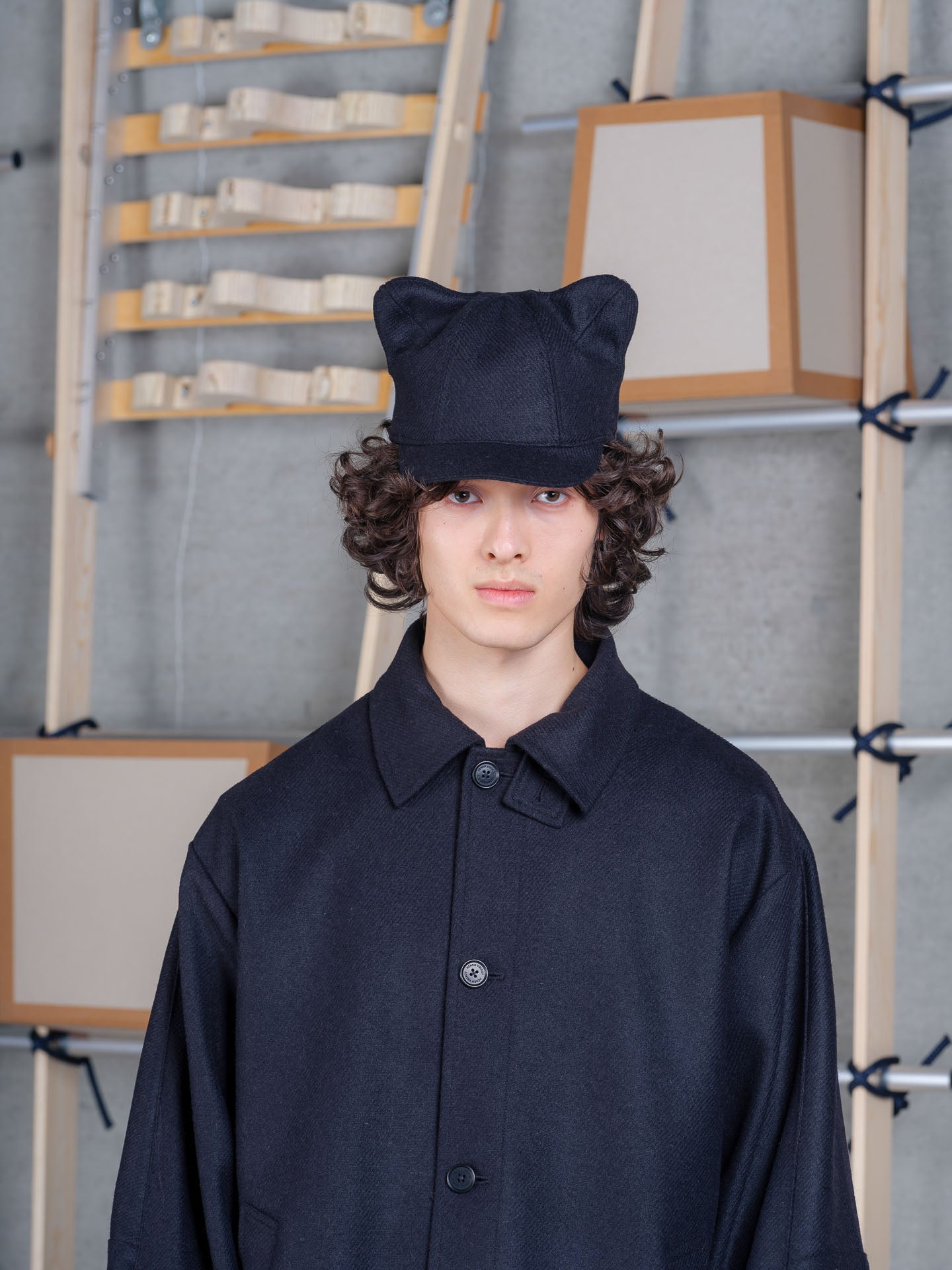 Model wearing Cara Eyed Cap in Black by Henrik Vibskov front view
