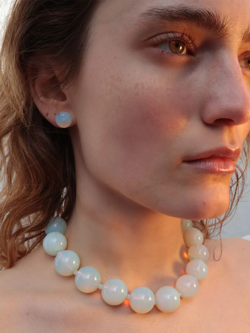 Model wearing the opal moon necklace with silver clasp from De Silang