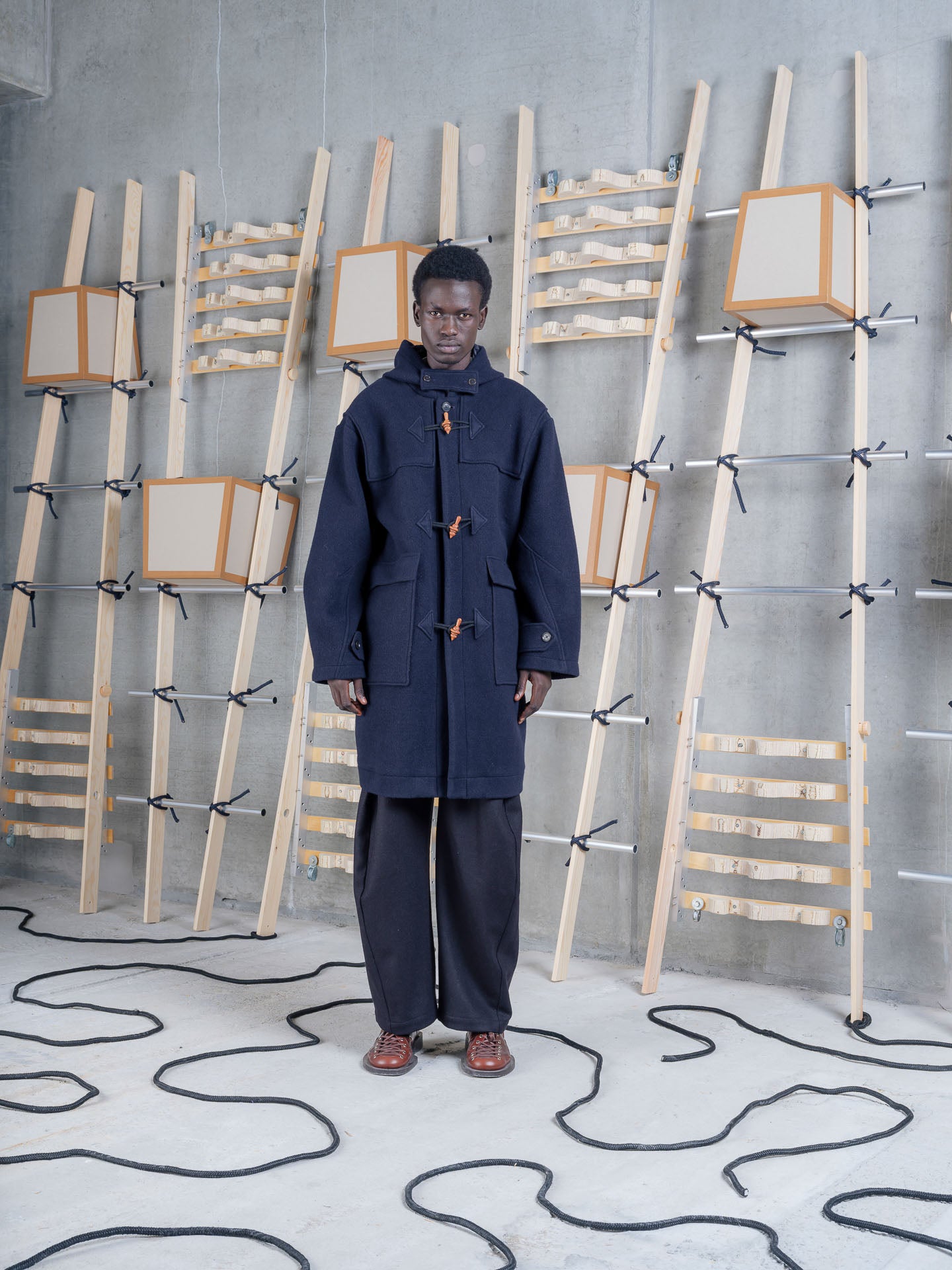 Model wearing Henrik Vibskov Duffle Coat in Navy Duffle front view
