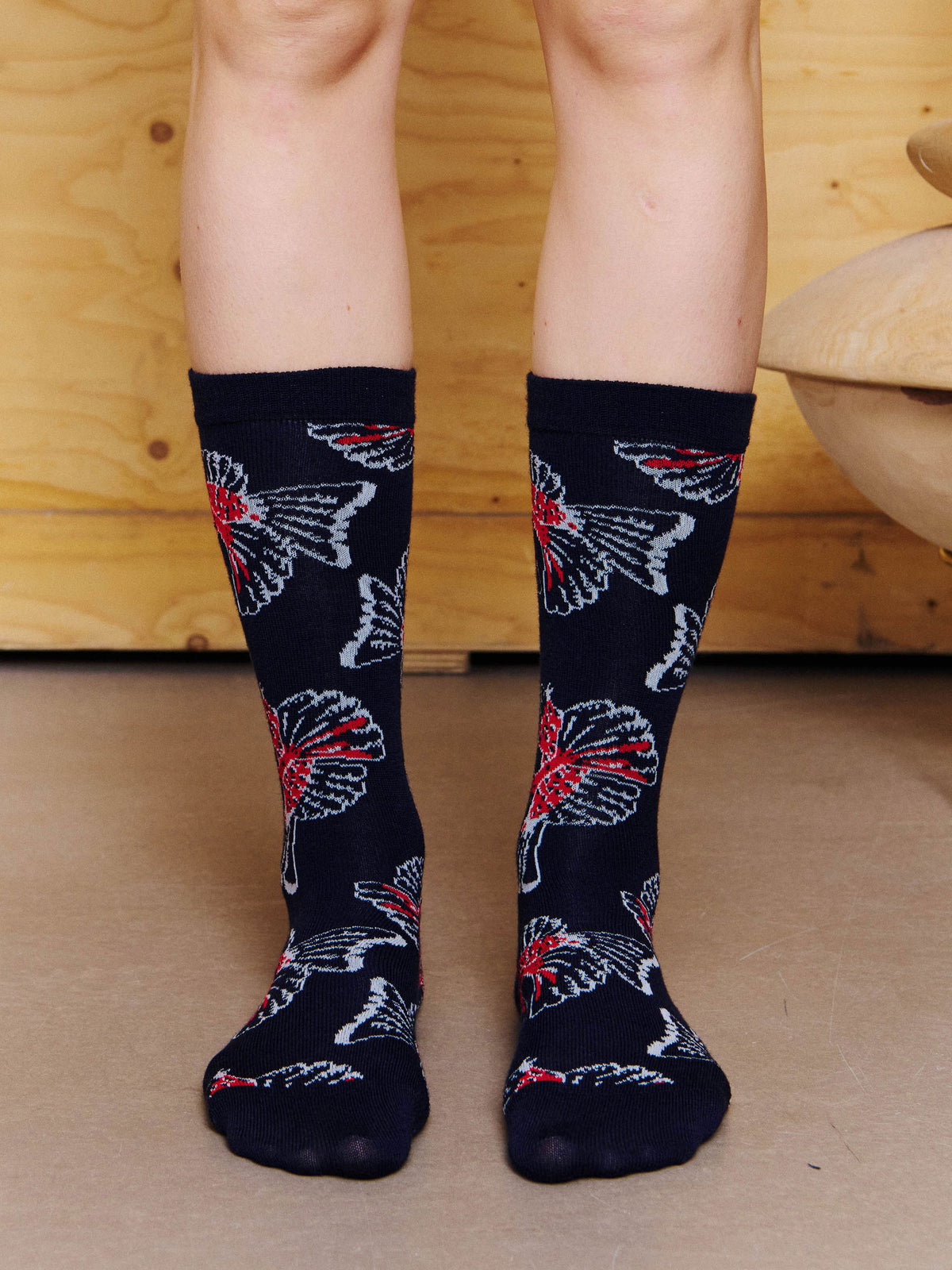 Henrik Vibskov Birdy Socks Anniversary in Navy Red Birdy worn front view, showing the graphic bird pattern and soft knitted construction.
