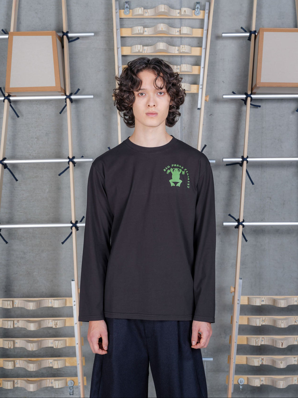 Henrik Vibskov Bug Press Blouse in Black worn on model, full-length front view, green frog graphic chest print, long-sleeve crew neck, relaxed fit
