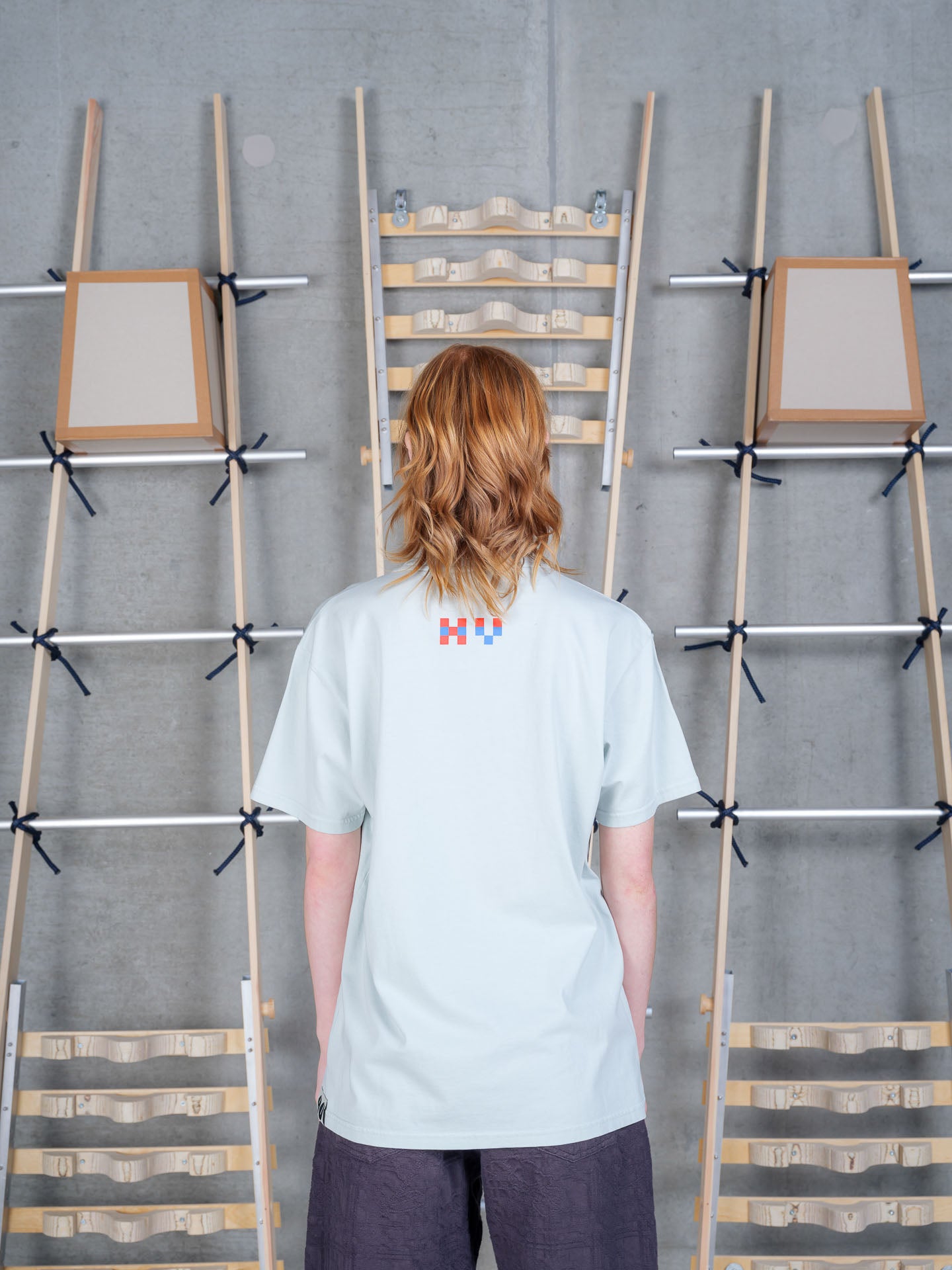 Henrik Vibskov Cross Stitch Tee in Sky Grey on-model back view, pale sky grey organic cotton, relaxed fit, crew neck