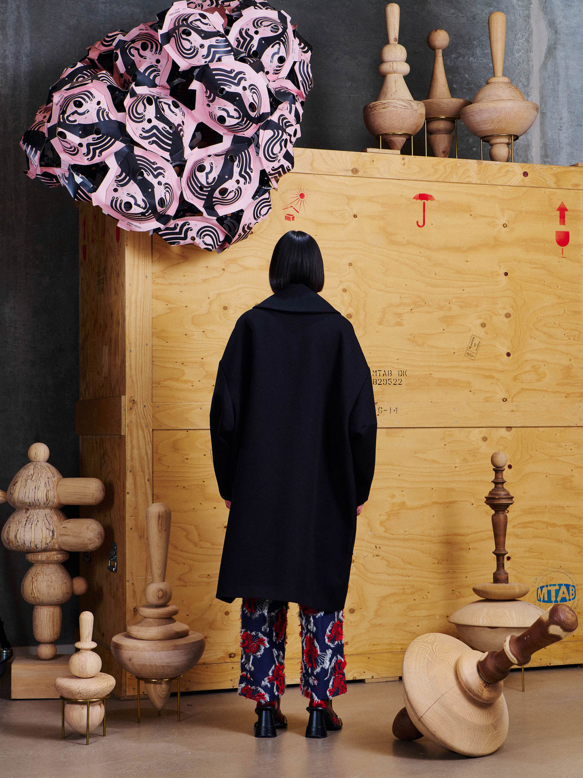 Back view of model wearing the Henrik Vibskov Floating Coat in Black, showing the clean oversized back and long silhouette.