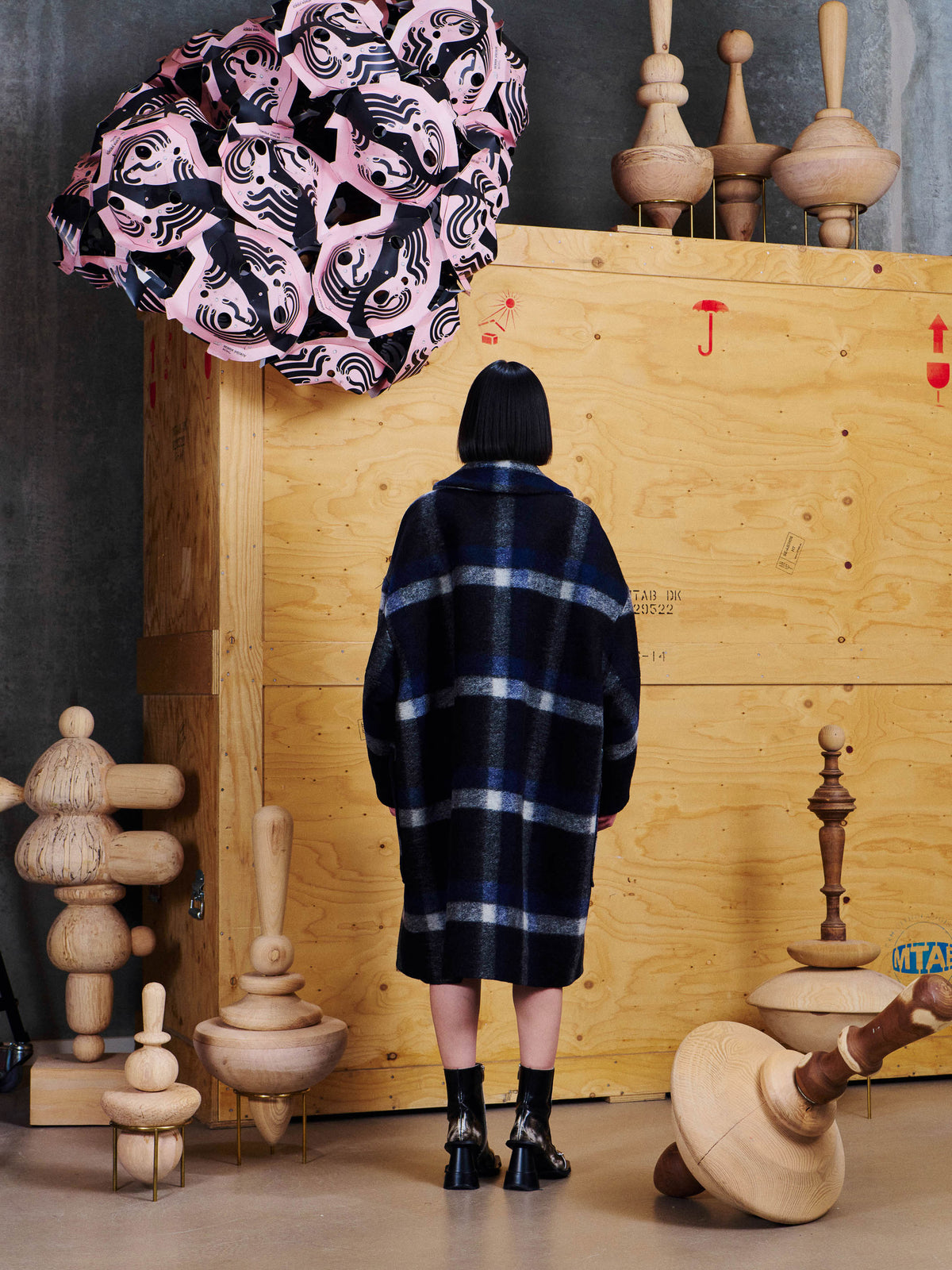 Henrik Vibskov Floating Coat in Dark Blurry Checks worn back view, showing the blurred check pattern, dropped shoulders and loose long silhouette.