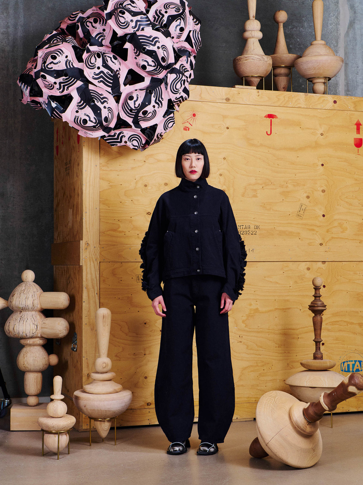 Model wearing the Henrik Vibskov Johnny Jacket in Black from the front, showing the relaxed fit, high collar and textured sleeve detailing.