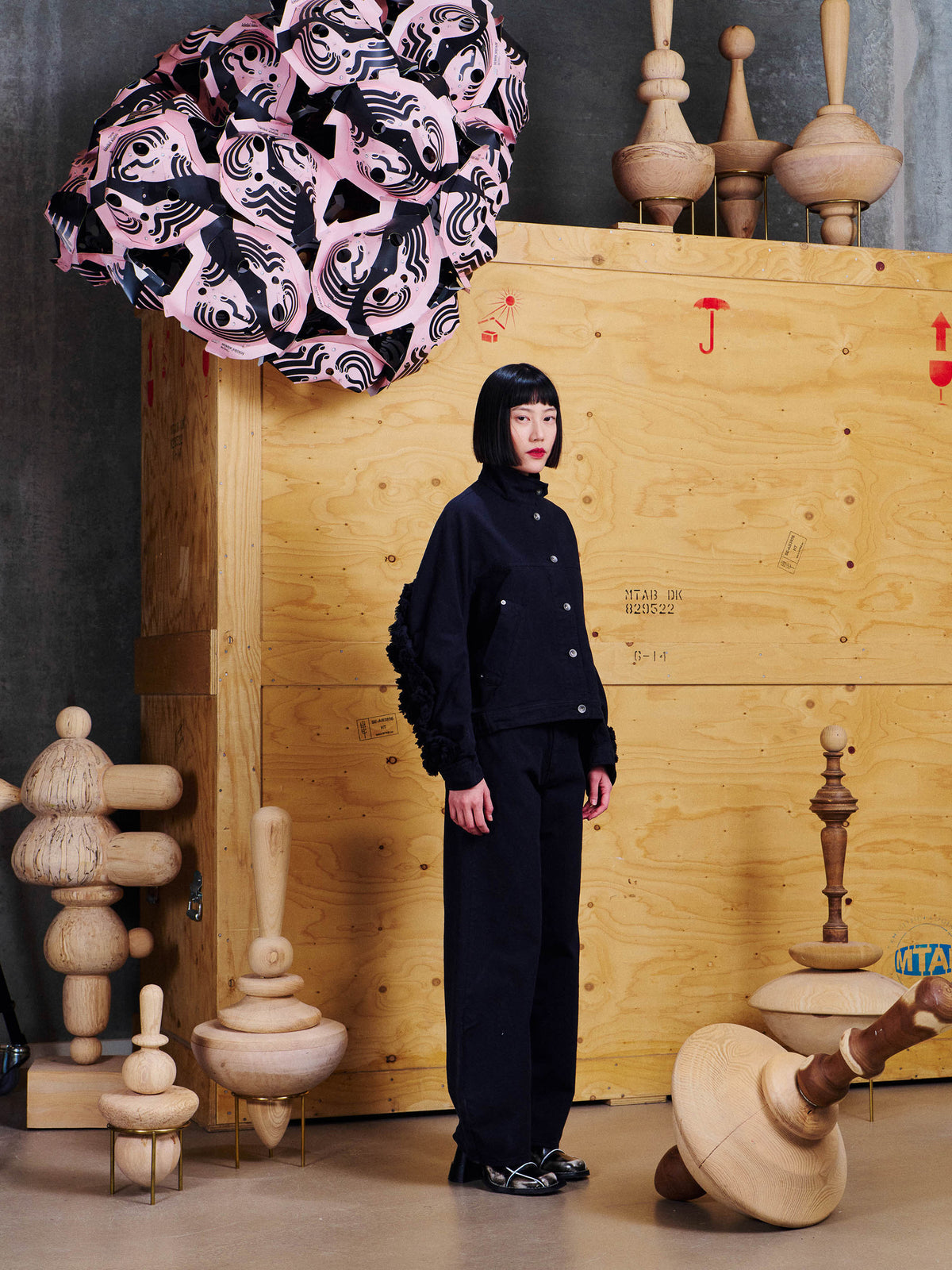 Side view of model wearing the Henrik Vibskov Johnny Jacket in Black, highlighting the dropped shoulders and voluminous fringe detailing along the sleeves.