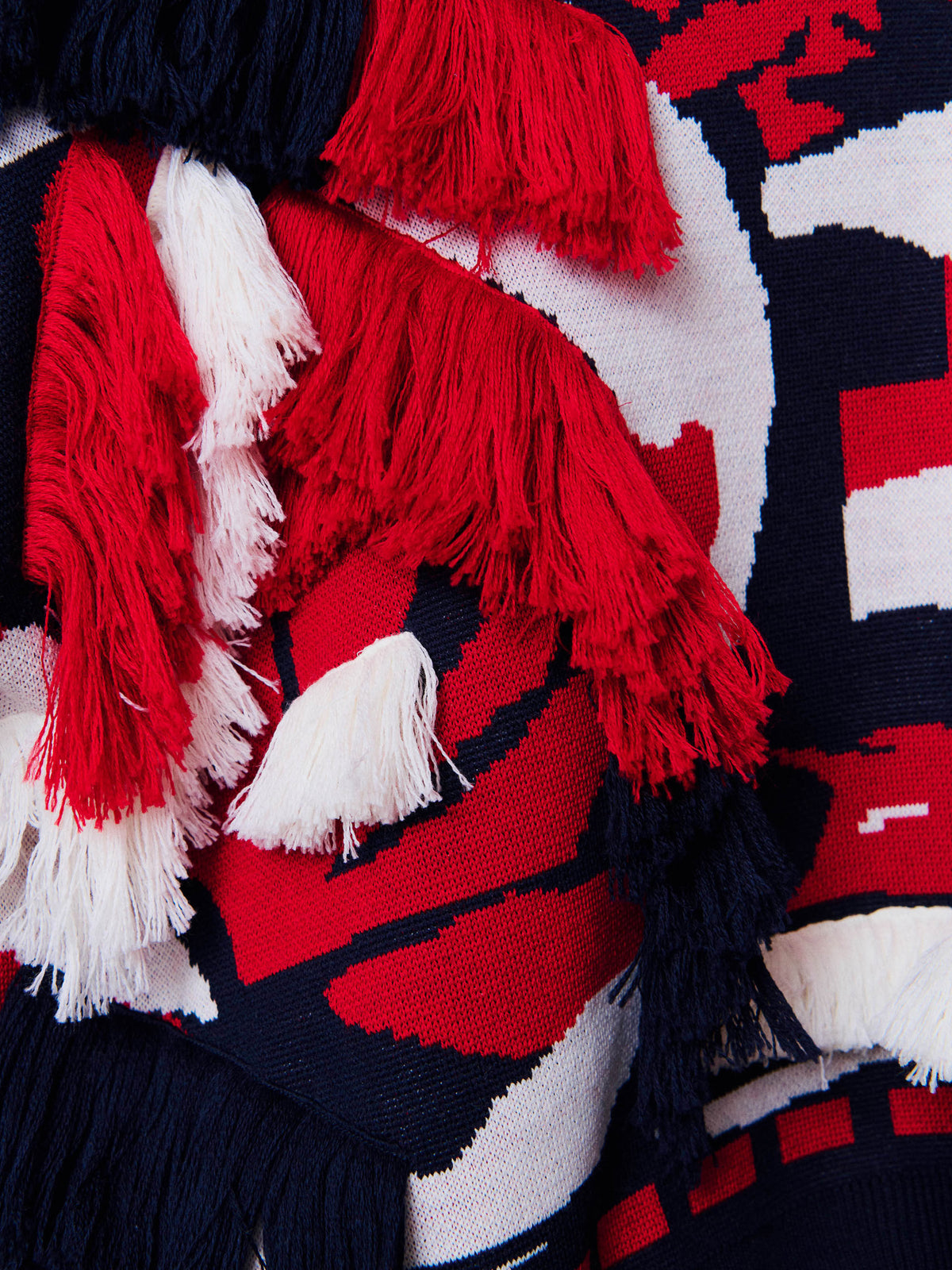 Close-up of Henrik Vibskov Knit Ham Onion Sweat showing red, navy and off-white jacquard knit texture with layered fringe details
