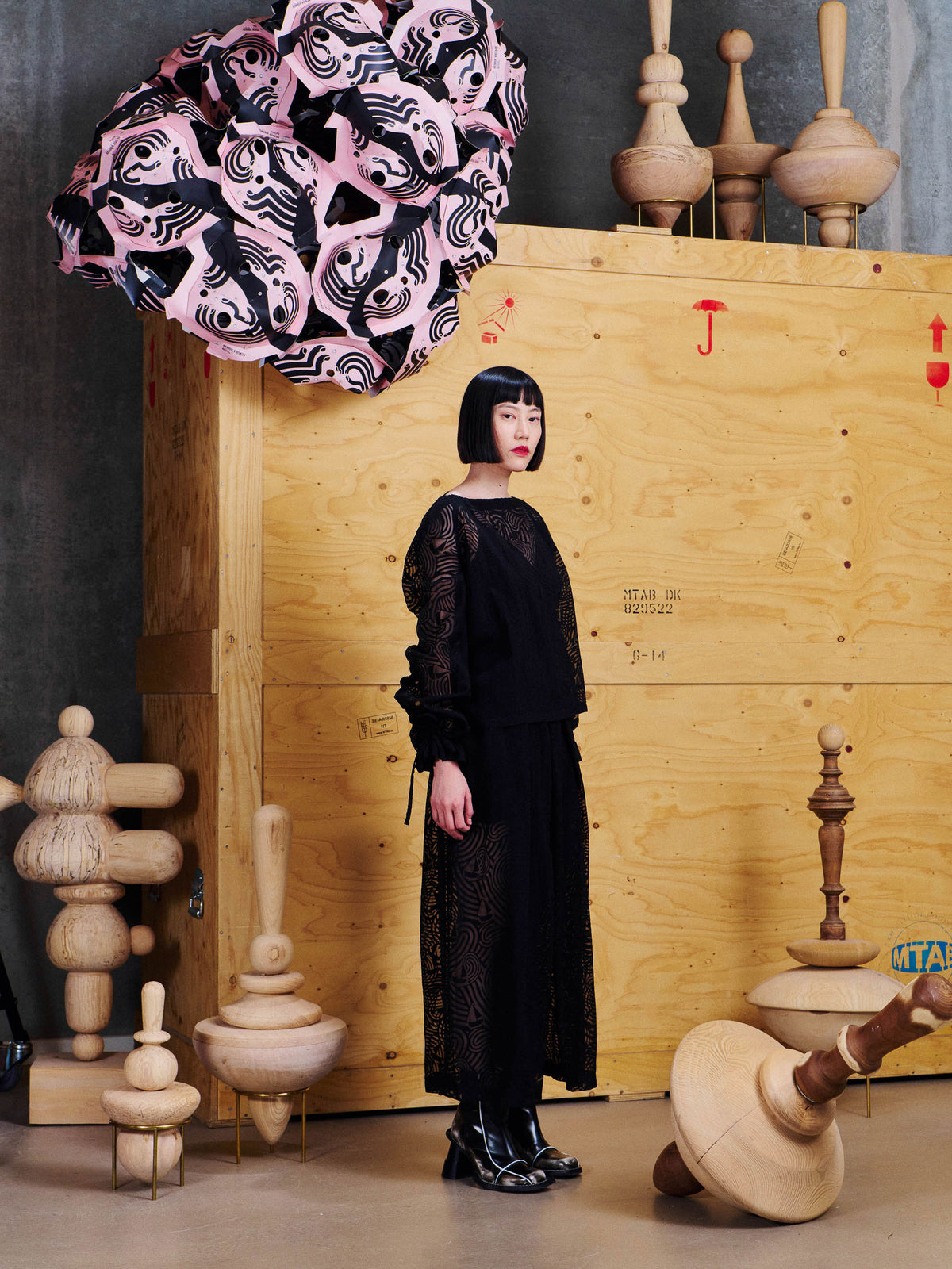 Henrik Vibskov Long Delivery Dress in Dark Stormy Sea styled on model from the side, showing voluminous sleeves, tie cuff details and flowing long silhouette. ID: ARCHIVE-F311