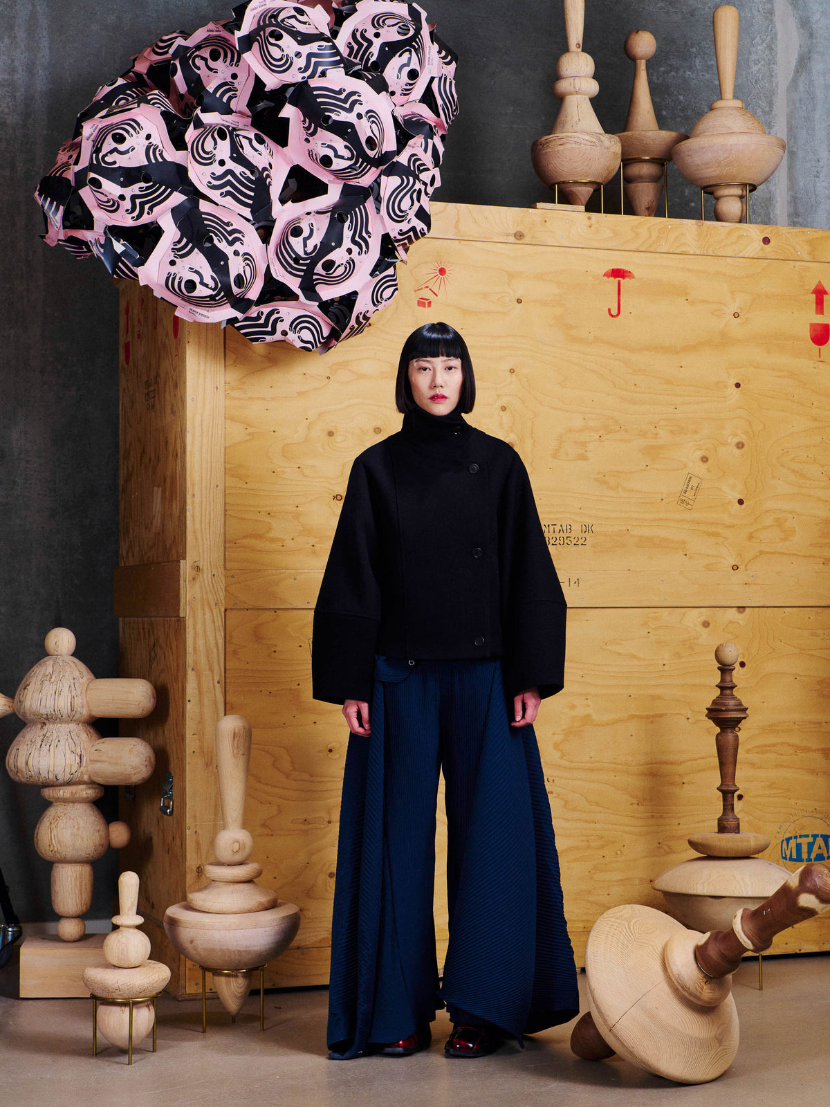 Model wearing the Henrik Vibskov Moon Short Jacket in Black from the front, showing the cropped silhouette, high collar and wide sleeves.