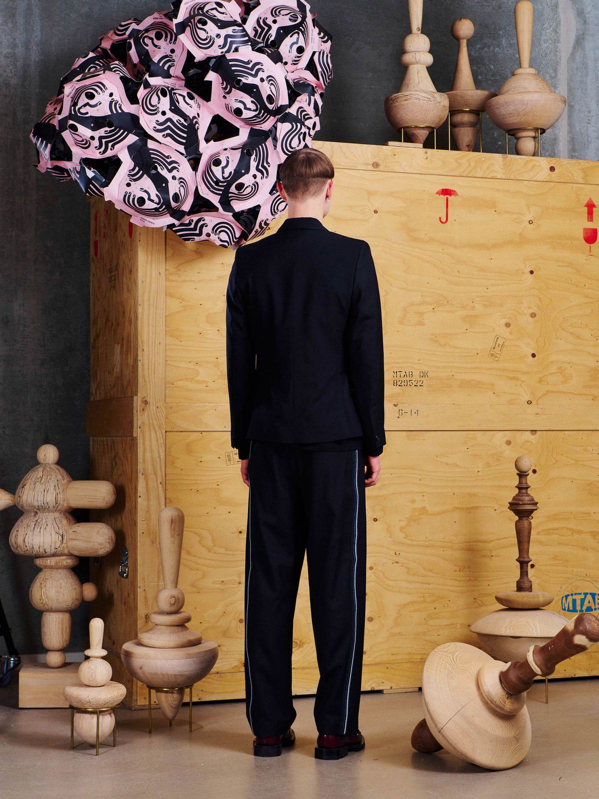 Back view of model wearing the Henrik Vibskov Motif Blazer, showing the clean tailored back and structured silhouette.
