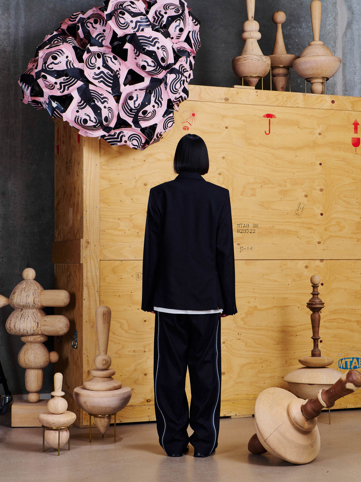 Back view of model wearing the Henrik Vibskov Motif Blazer, showing the clean tailored back and structured silhouette.