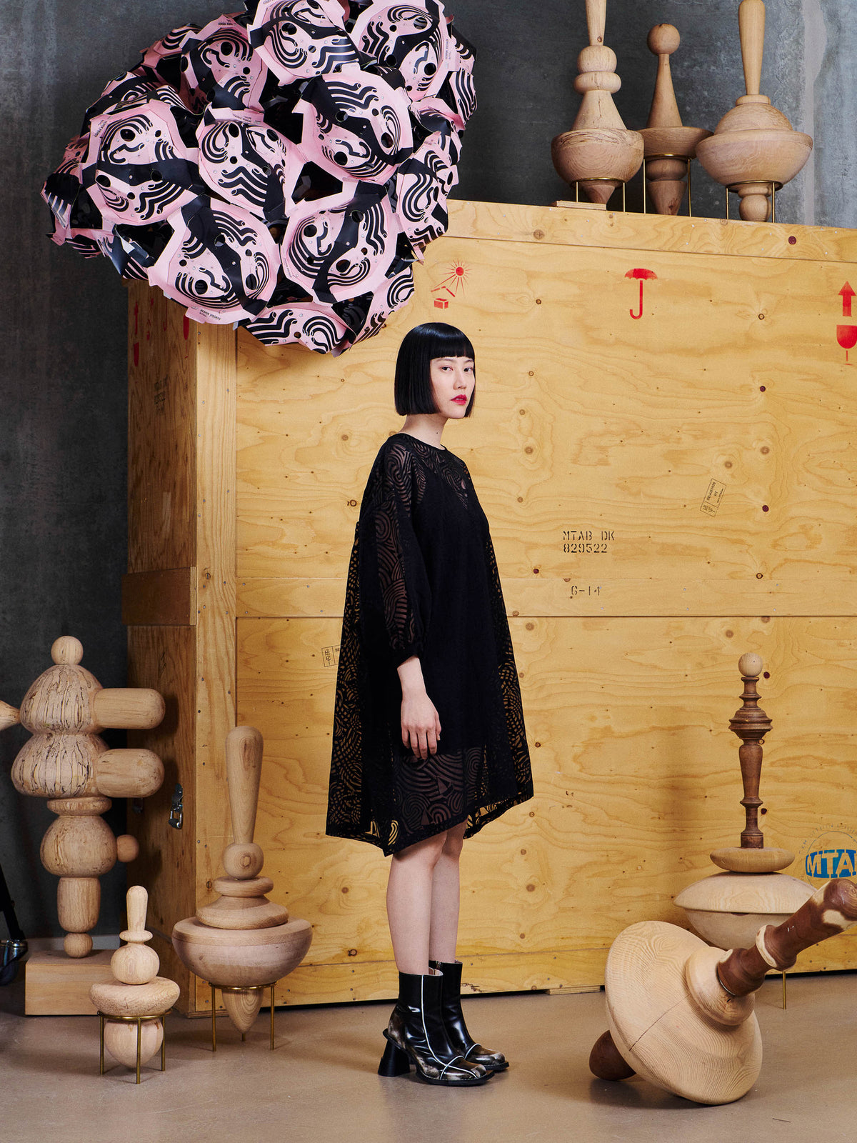 Side view of model wearing the Henrik Vibskov Non Chalant Dress in Dark Stormy Sea, showing the loose shape, three-quarter sleeves and asymmetric hem.