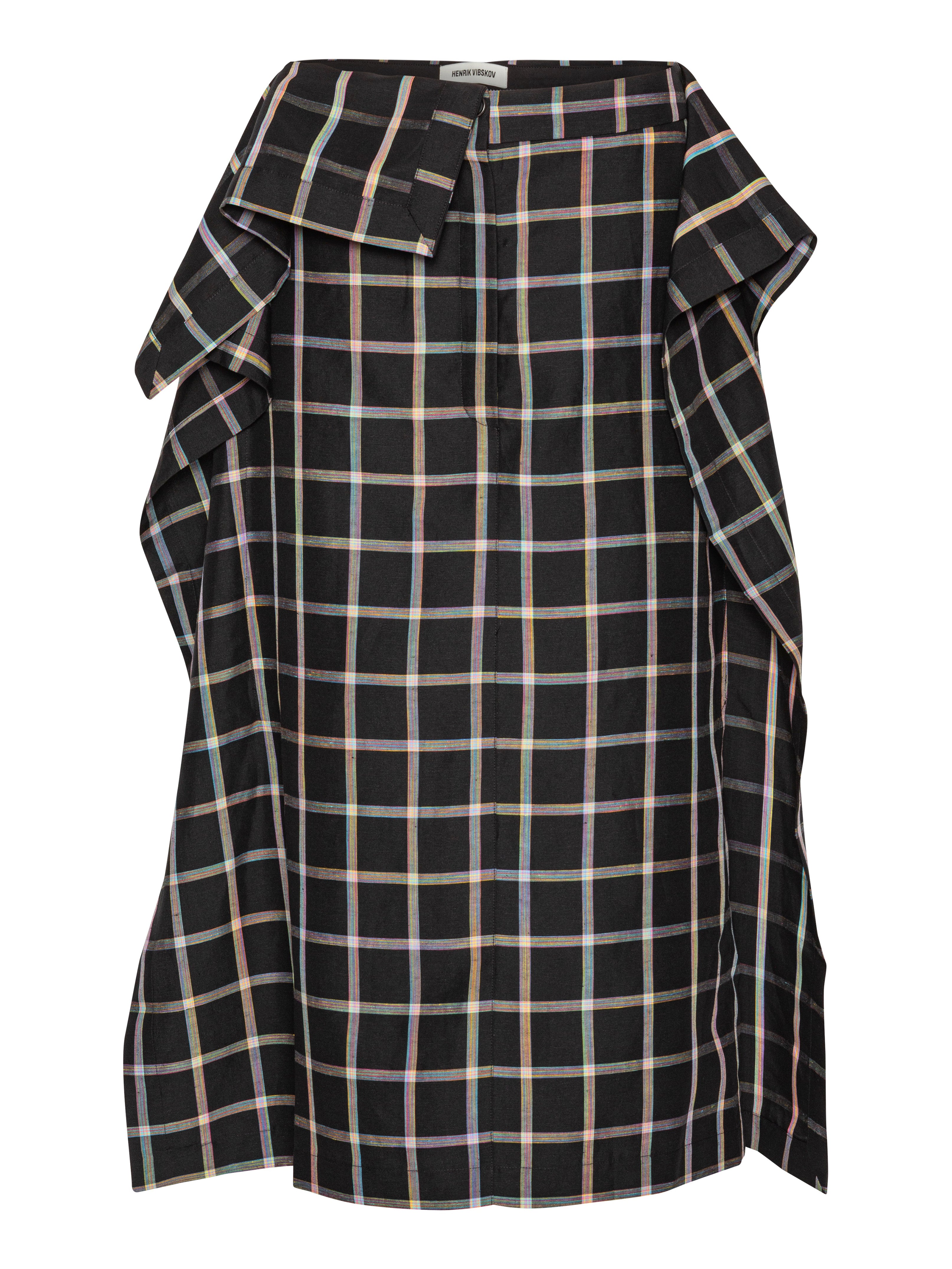Front view of the Henrik Vibskov Ocu Skirt in Black Checks, showing the black check pattern, extra fabric design, side pockets, side slit, and straight hem.
