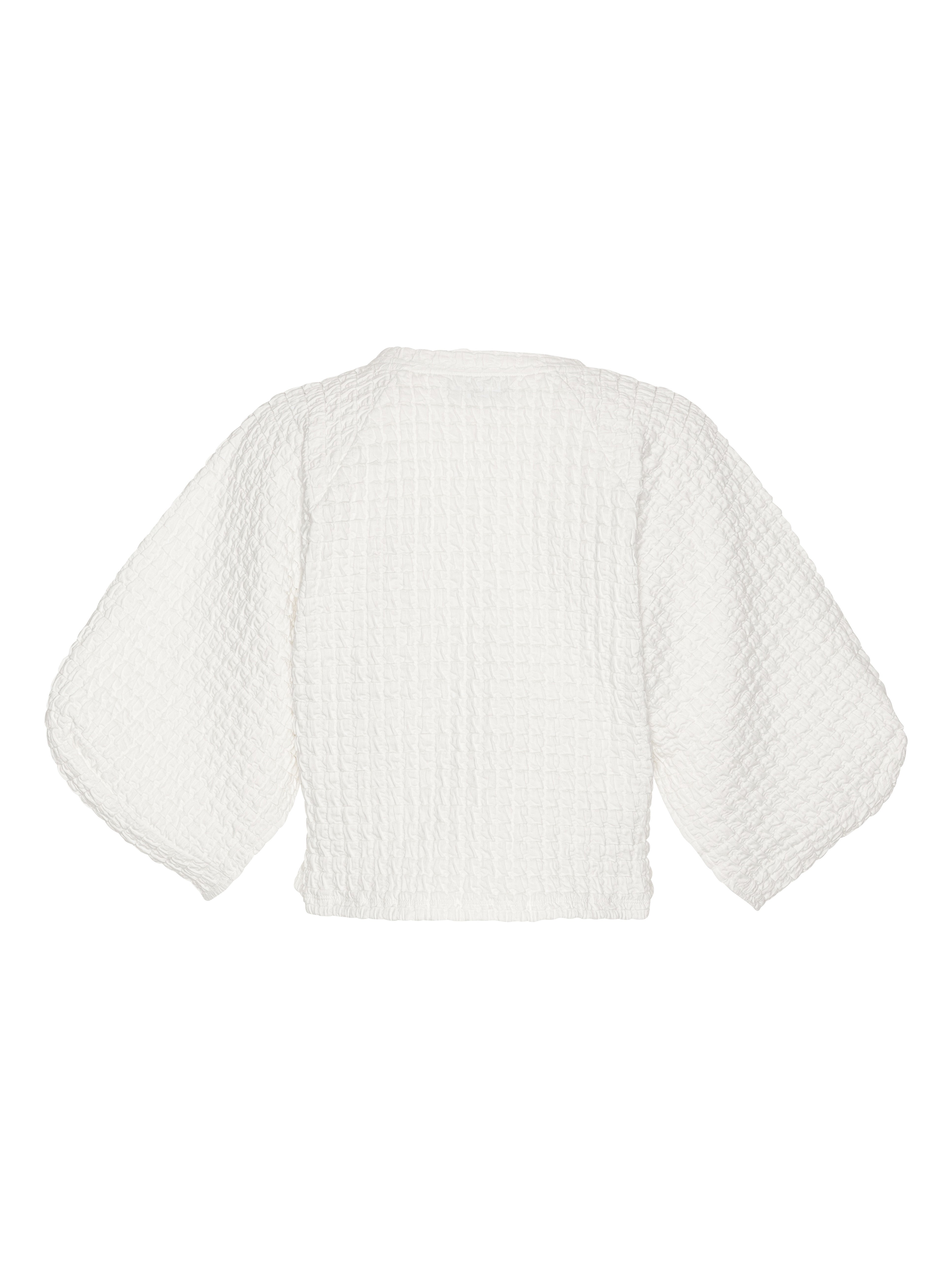 Back view of the Persey Top highlighting the straight cropped hem and full shape of the 3/4 sleeves.