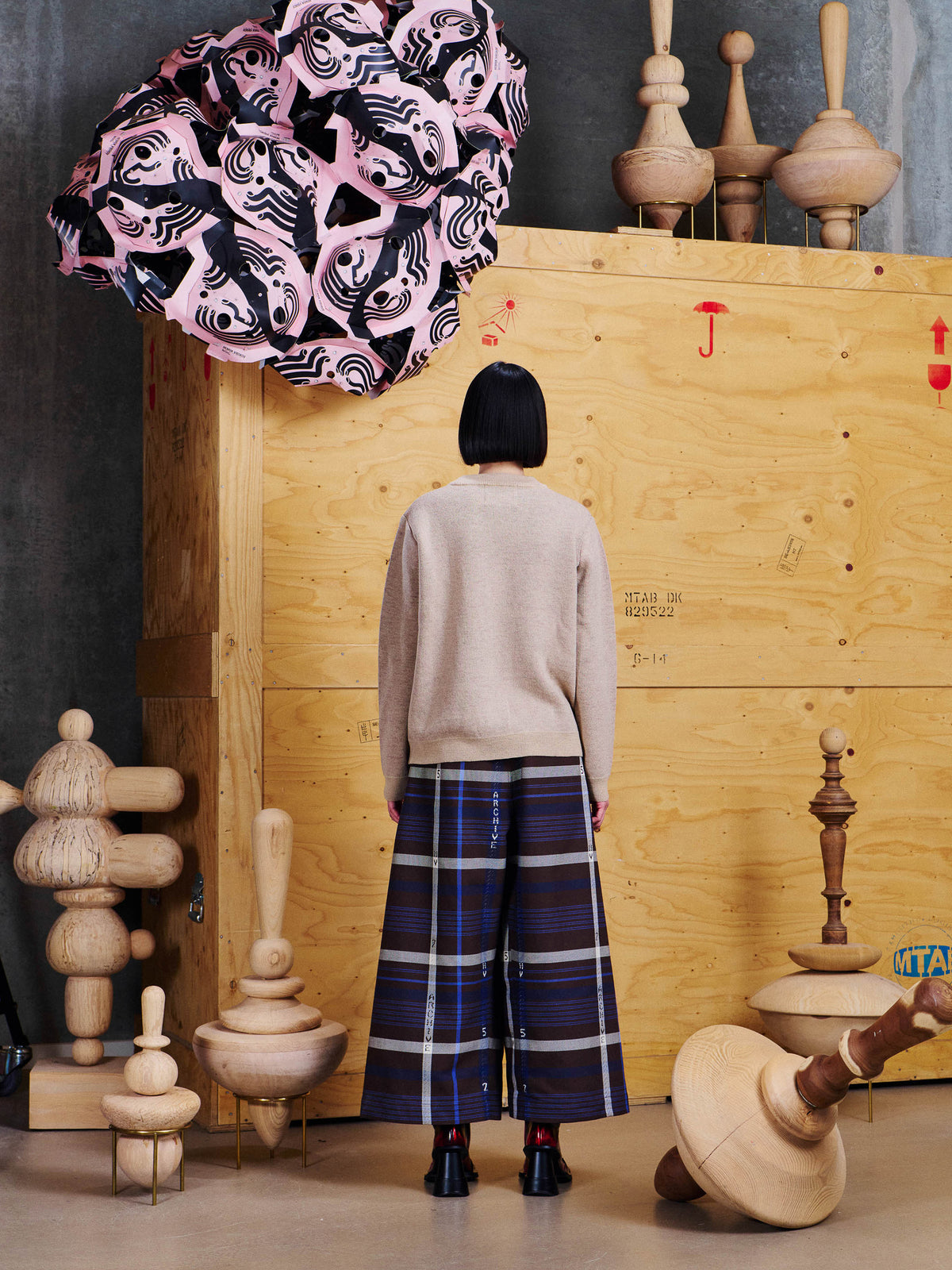 Back view of Henrik Vibskov Pound Pants in Brown Navy Archive showing wide cropped fit, brown navy check pattern and voluminous shape