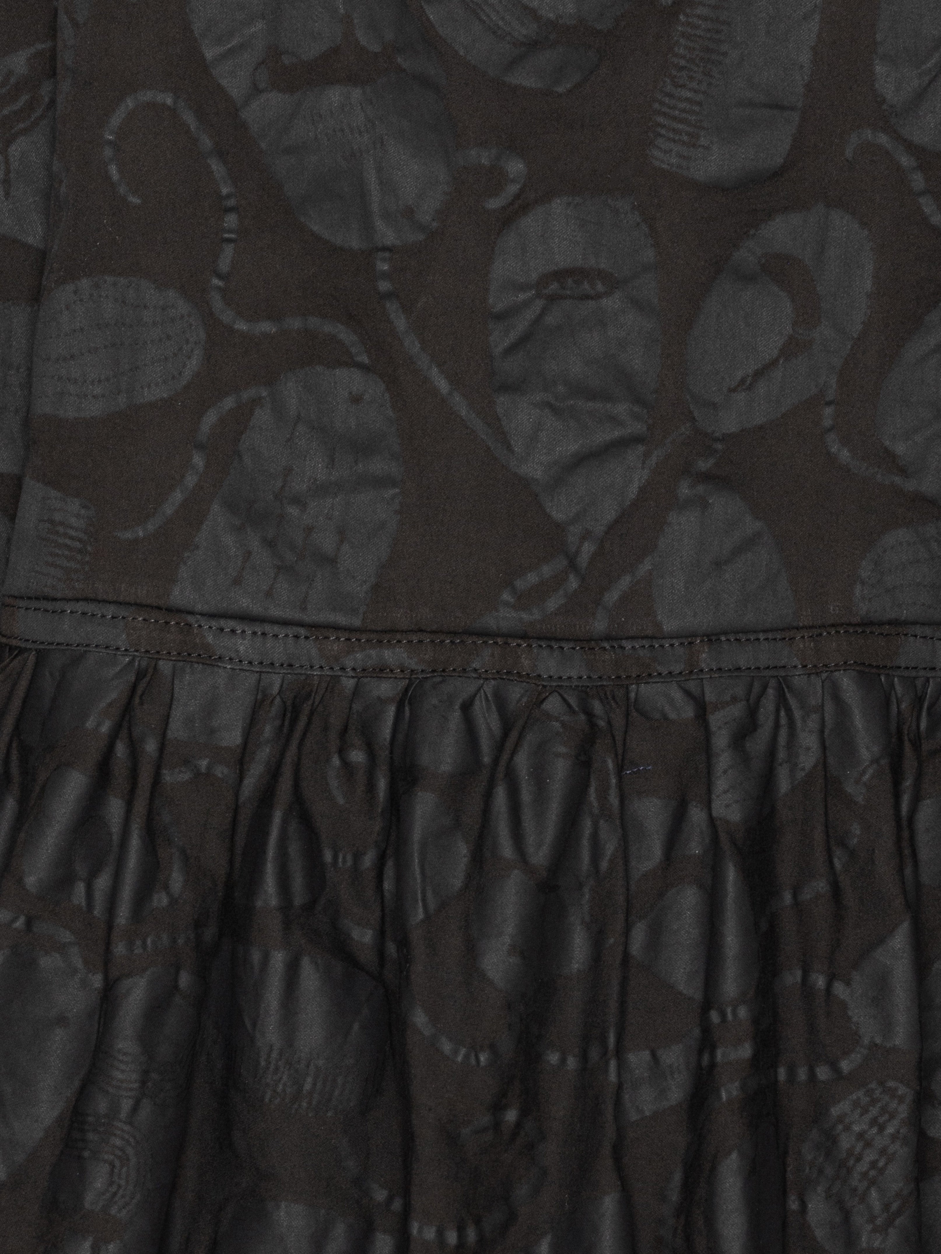 Close-up of the Henrik Vibskov Preserve Blouse in Black Amulets, highlighting the amulet pattern, V-neck detail, and fabric texture.