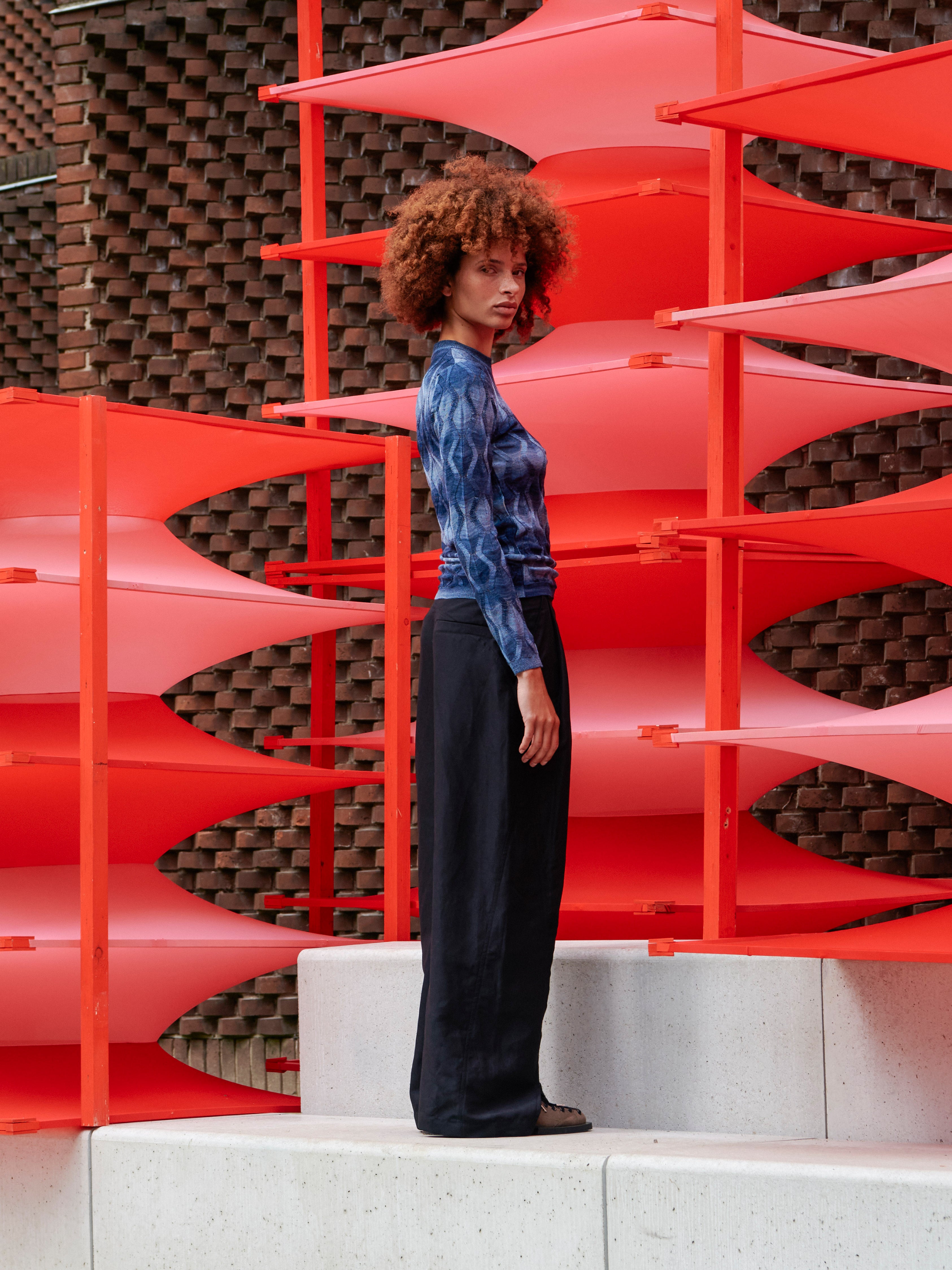 Model wearing the Resonance Longsleeve in Navy Flame blue patterned long sleeve top with ribbed hems and second-skin fit, side view – Henrik Vibskov Spring/Summer 2026 Key Collection