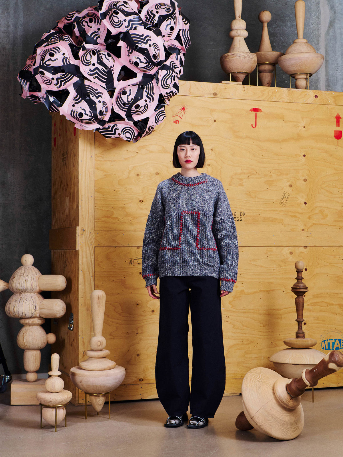 Henrik Vibskov Stitch Jumper in Red Stitch Grey Melange worn front view, showing the relaxed fit, dropped shoulders and red stitched panels.