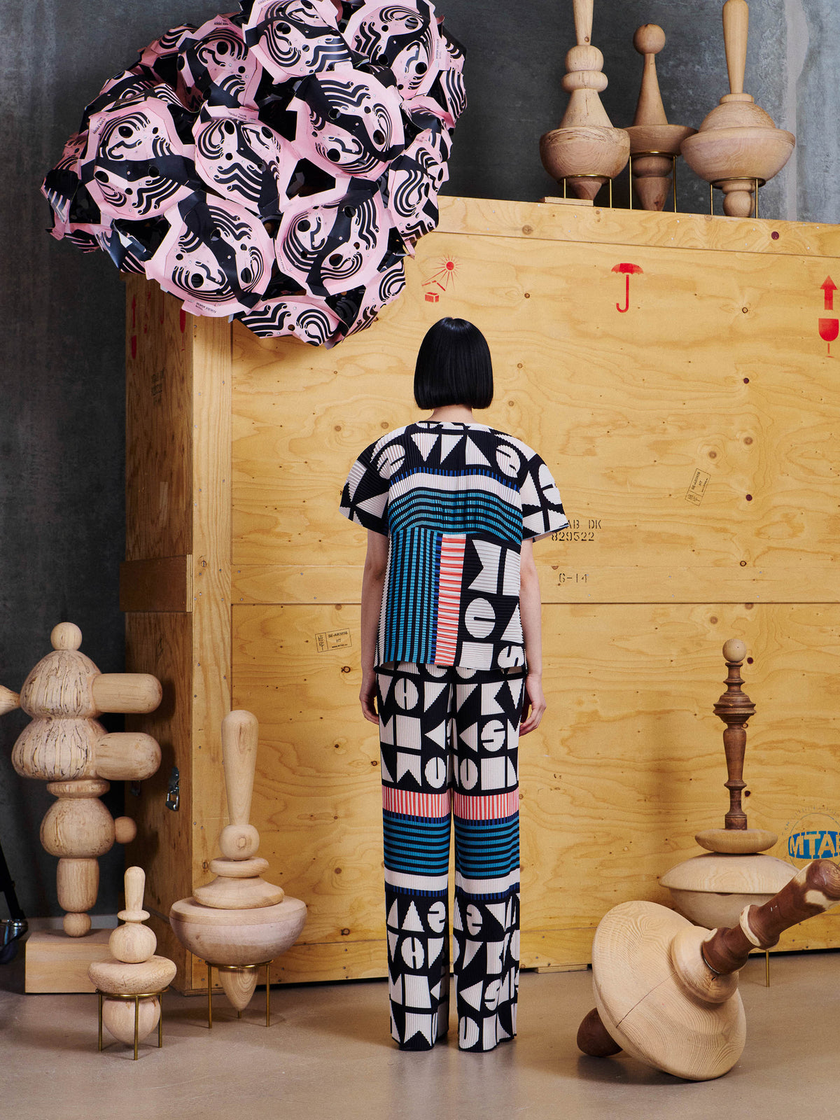 Back view of female model wearing Henrik Vibskov Thumb Plisse Blouse, showing the graphic pattern placement and pleated texture.