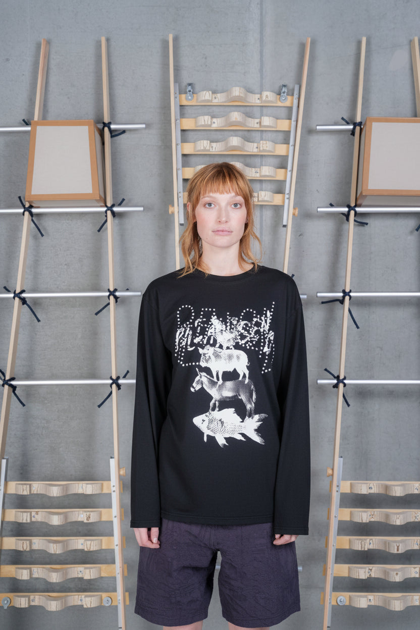 Front view of a female model wearing the Henrik Vibskov Tower Swamp Blouse in Black, showcasing the oversized stacked animal graphic, crew neckline, and relaxed long-sleeve fit.